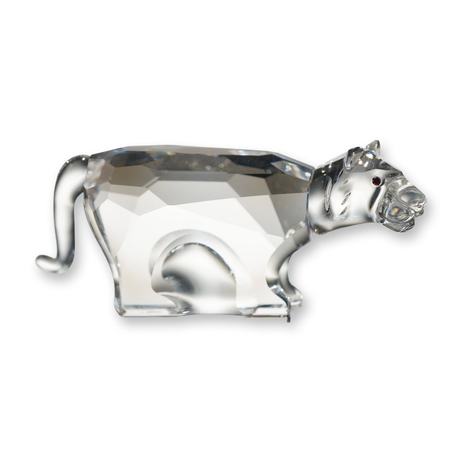 Swarovski Crystal Zodiac Tiger Figurine: Swarovski crystal figurine depicting a tiger from the Chinese Zodiac series. Crafted in faceted clear crystal with dark inset crystal eyes. Features an etched Swarovski swan logo and copyright mark