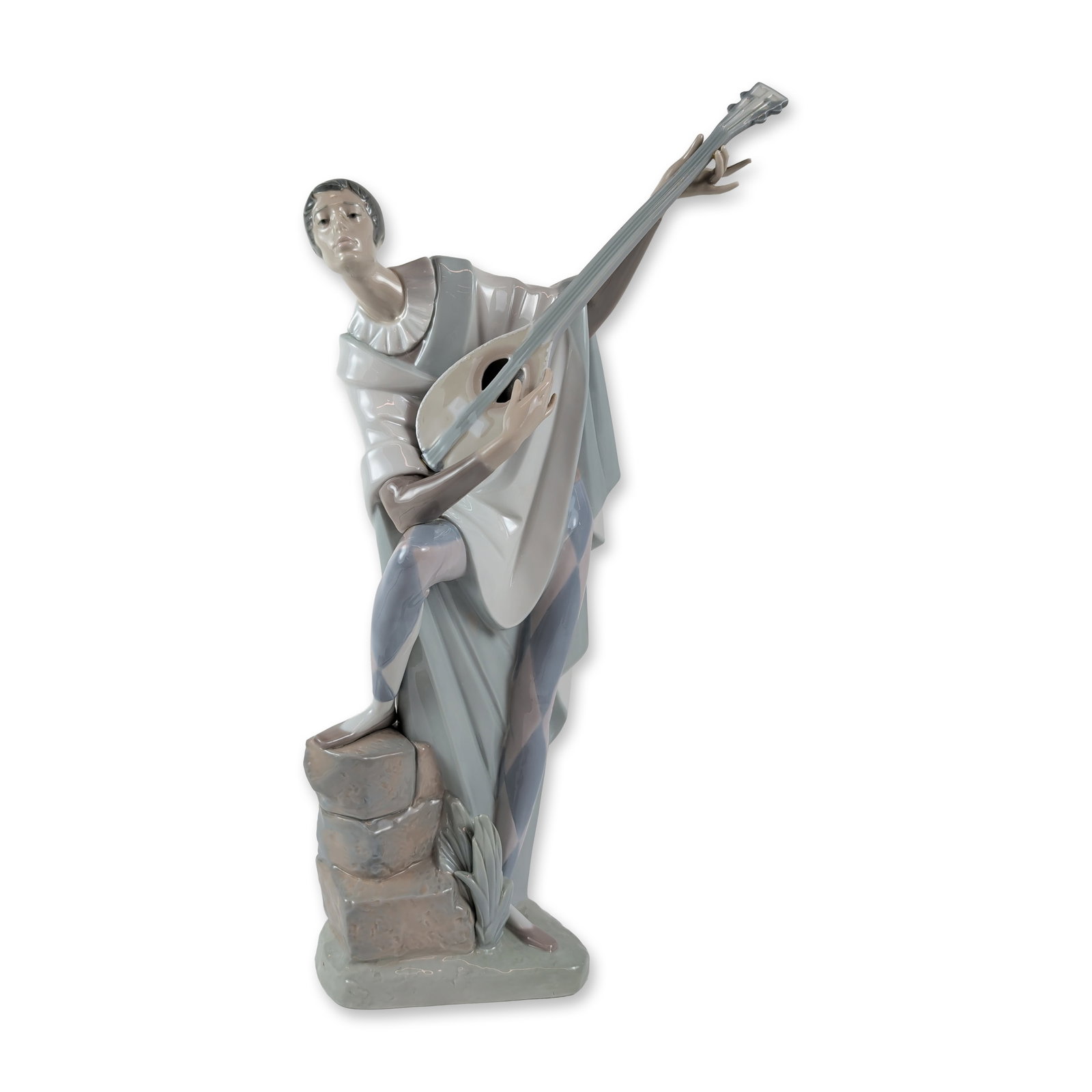 Lladro Spanish Glazed Porcelain Troubadour in Love Lladro Sculpture: Spanish, 20th century. Lladro glazed porcelain figurine titled Troubadour in Love Lladro model number 4699. The large-scale sculpture depicts a stylized harlequin figure in flowing robes and patterned