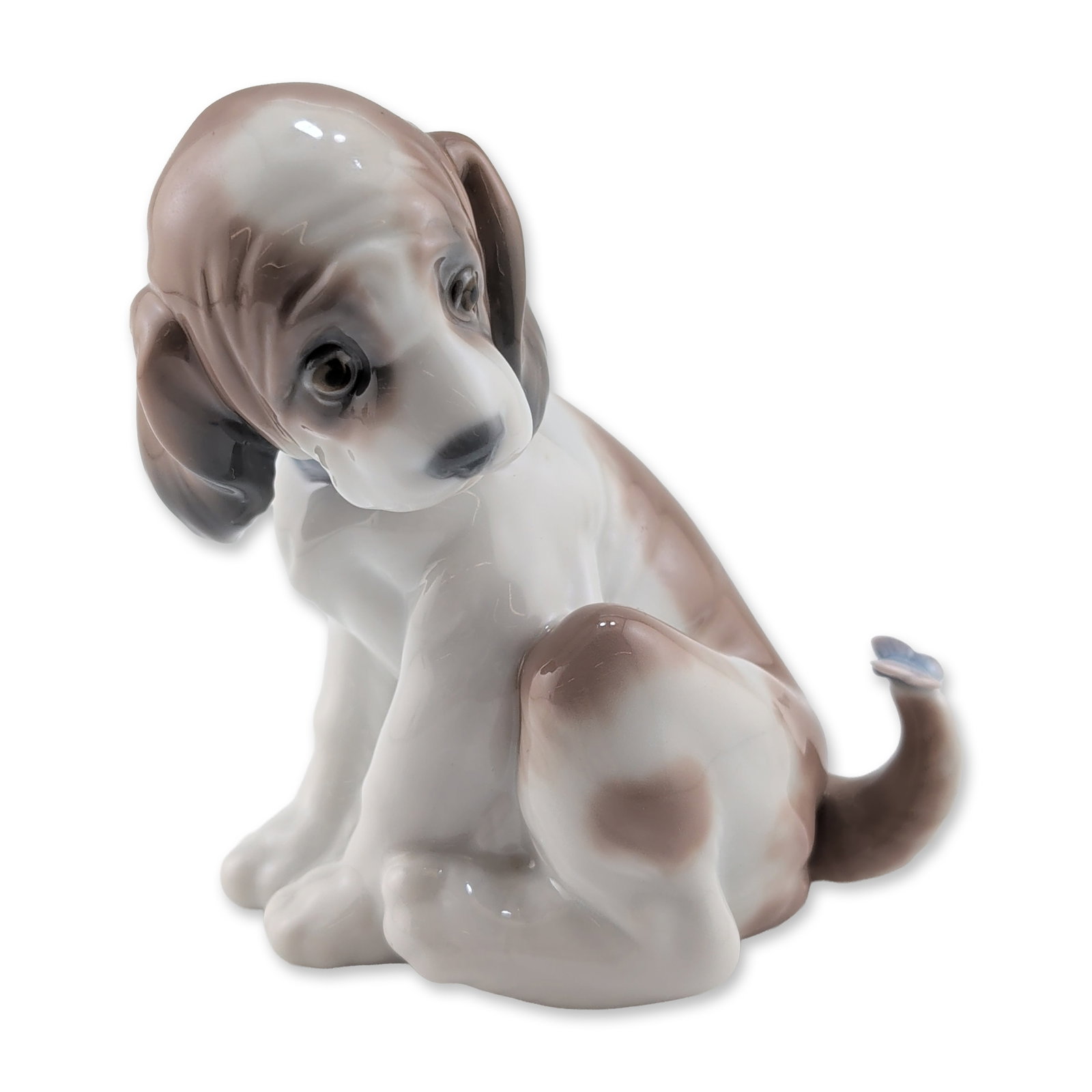 Lladro Gentle Surprise Porcelain Puppy Figurine: Lladro Spanish glazed porcelain figurine titled Gentle Surprise, model number 6210. The piece depicts a seated white puppy with soft brown patches and a pale blue collar, turning to look at a small bl
