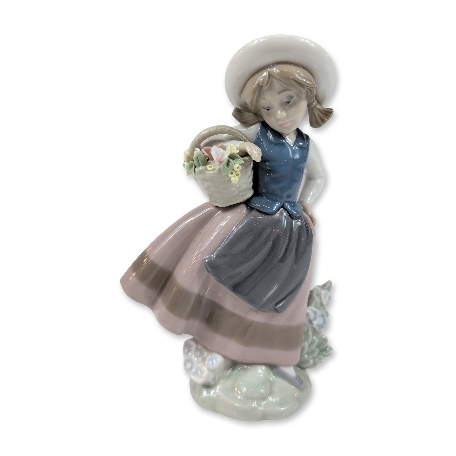 Lladro Spanish Porcelain Sweet Scent Figurine: Lladro (Spain). Glazed porcelain figurine titled Sweet Scent, model number 5221, depicting a young girl in rustic attire. The figure wears a wide-brimmed sun hat, a blue bodice over a white blouse, a 