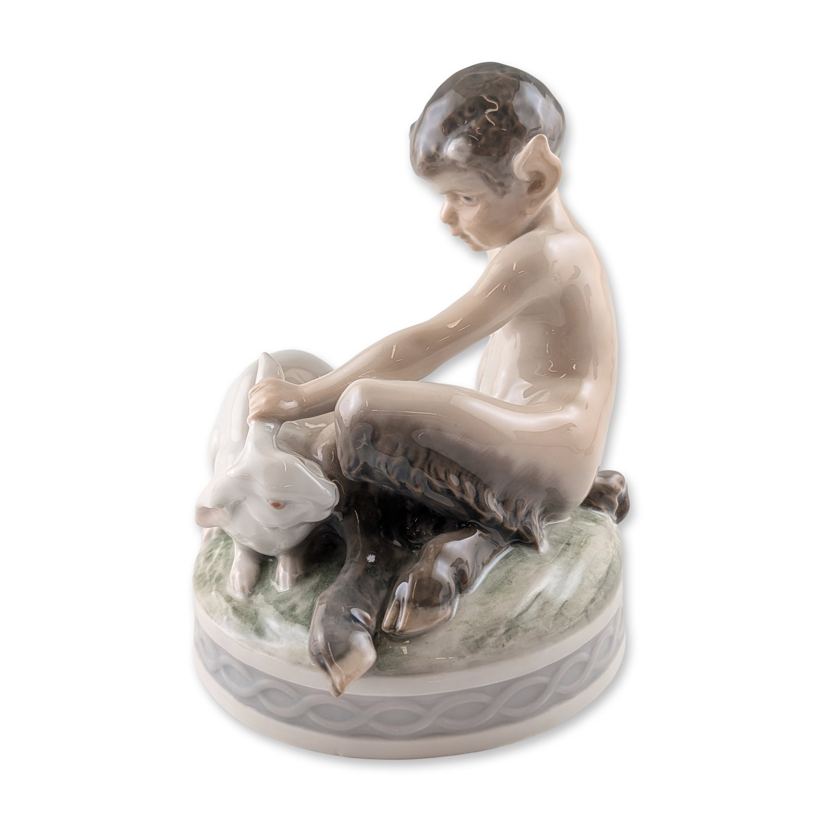 Royal Copenhagen Christian Thomsen Porcelain Faun with Rabbit Figurine: Royal Copenhagen porcelain figurine designed by Christian Thomsen, titled Faun with Rabbit, model number 439. The figure depicts a young faun with characteristic horns and goat legs seated on a grassy