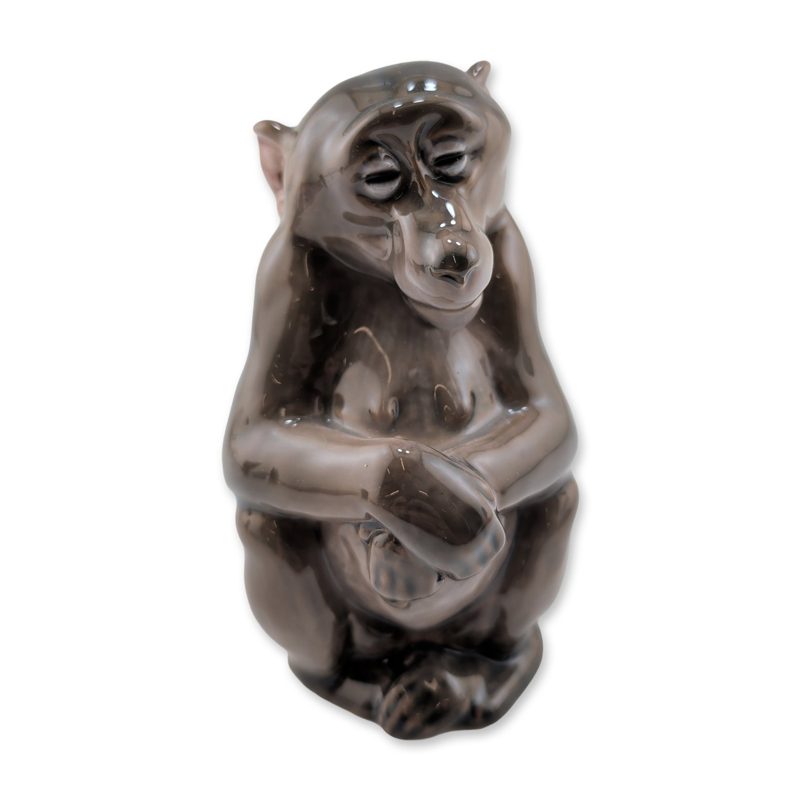 Royal Copenhagen Pregnant Porcelain Monkey Figurine: Royal Copenhagen porcelain figurine designed by Niels Nielsen, model number 1444. The piece depicts a seated monkey in a hunched position with hands clasped at the chest, finished in a variegated high