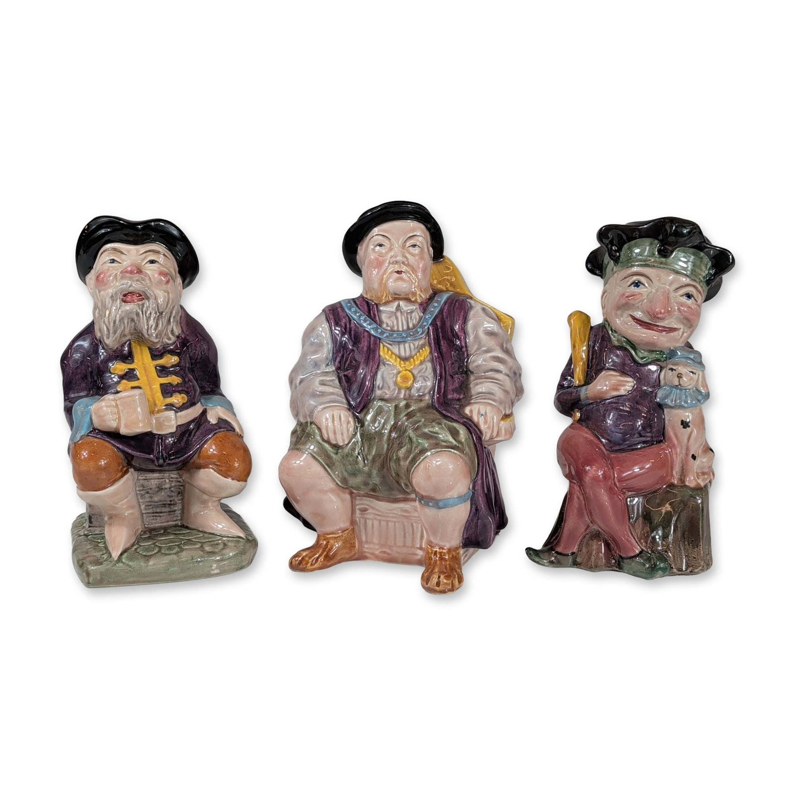 3pc Melba Ware English Toby Jugs: Melba Ware, English. Trio of polychrome glazed ceramic character jugs manufactured by H. Wain and Sons Ltd. at the Melba Works in Longton, Stoke-on-Trent. Each vessel features a handle integrated into