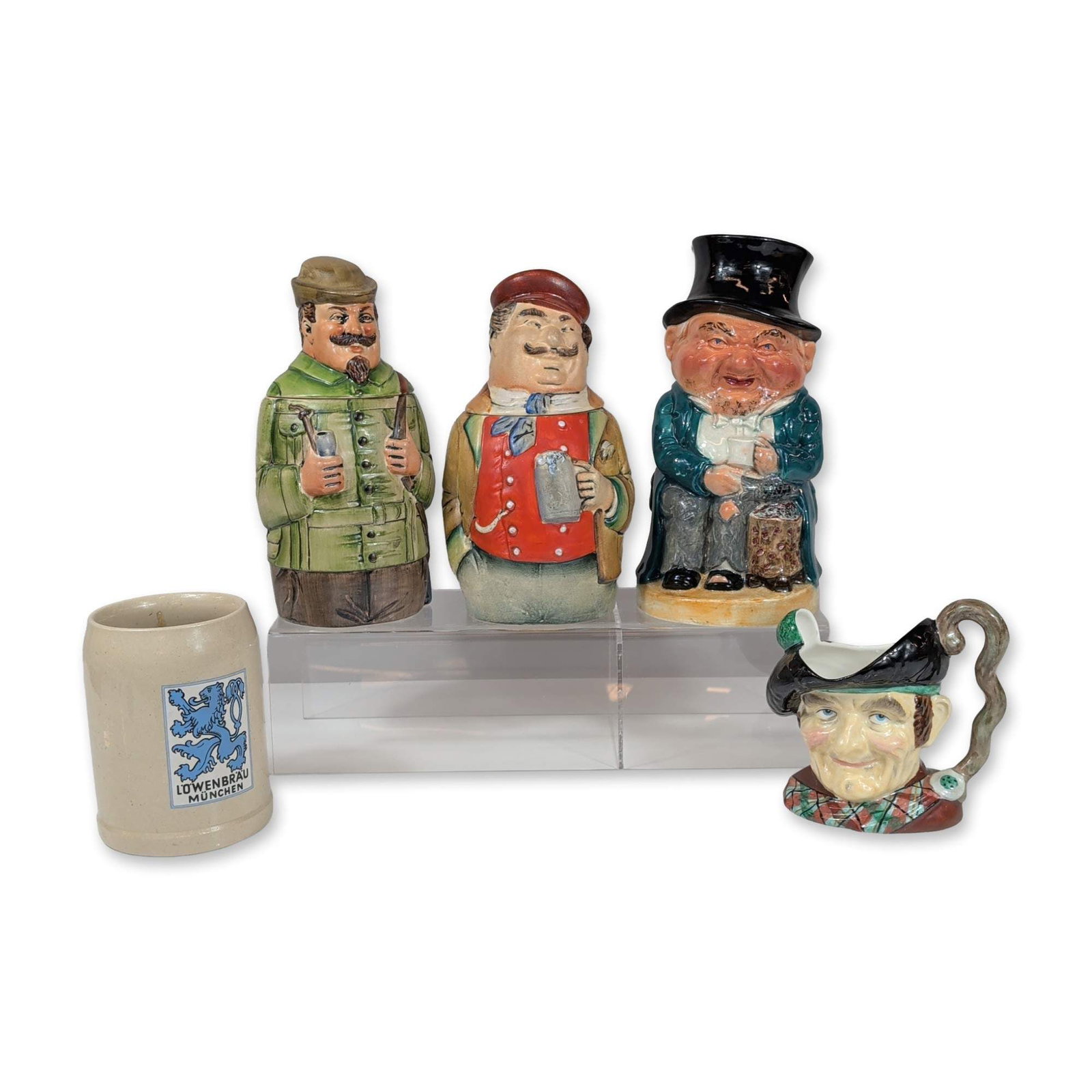 5pc Collection of English and German Character Steins and Jugs: Collection of five ceramic and stoneware vessels produced in England and West Germany. Manufacturers marks are present on the base. Weight: 8 lbs Height: 9.25 inches Width: 7.0 inches. Dimensions: 7.0