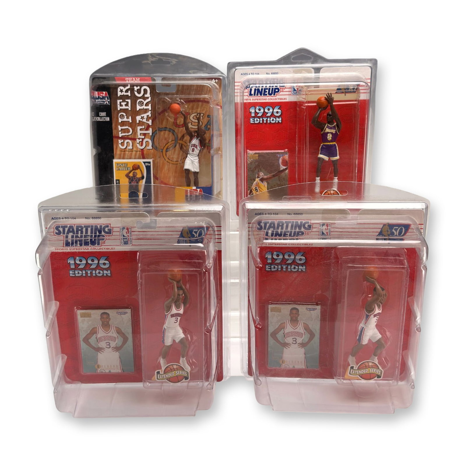 4pc NBA and USA Basketball Figurines Including Kobe Bryant, Allen Iverson, and Vince Carter: This lot consists of four vintage basketball action figures in their original retail packaging, with each item housed in an additional protective clear plastic clamshell display case. The collection i
