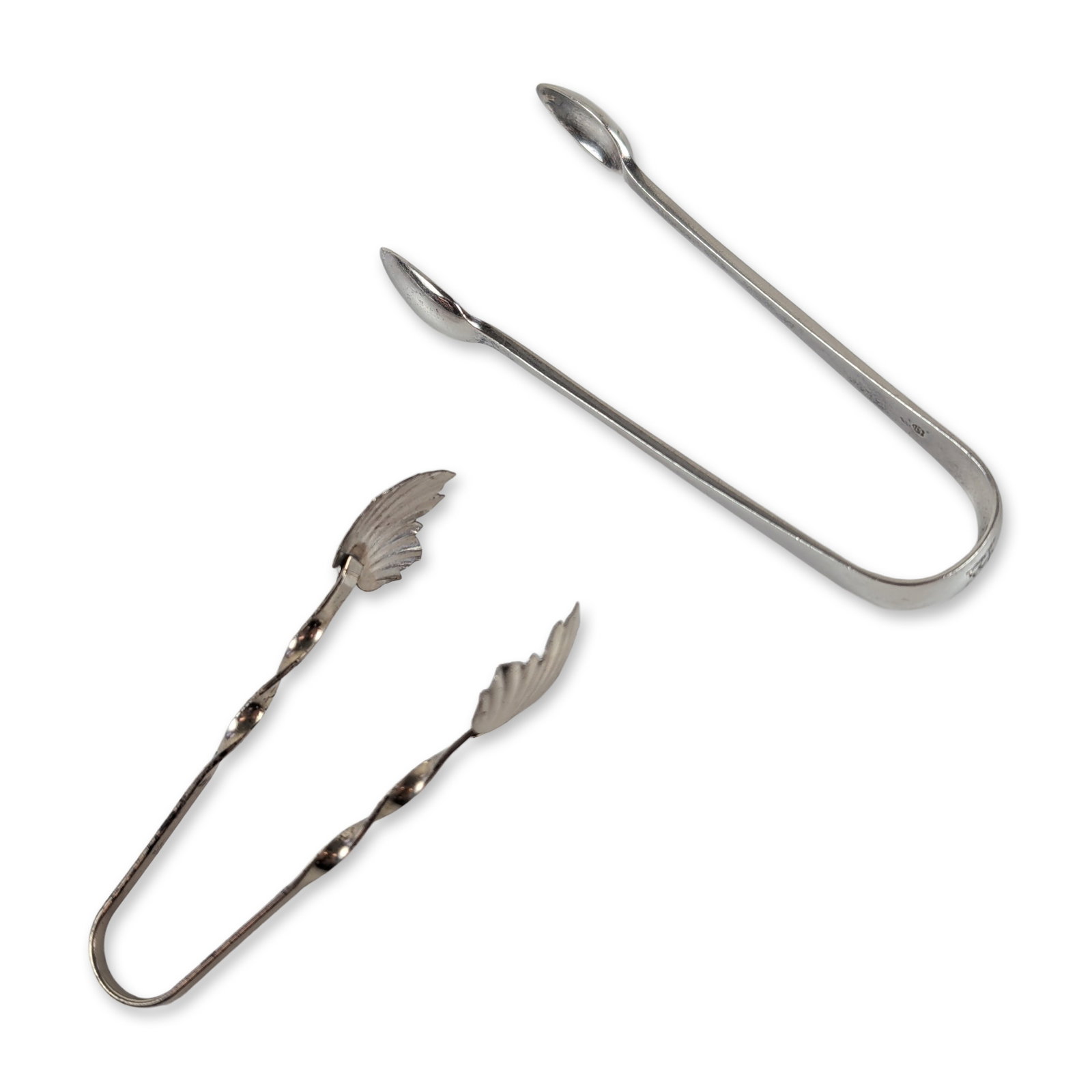2pc Sterling Silver Sugar Tongs includes Raimond Sterling: Sterling silver sugar tongs with oval spoon-shaped grips, engraved with a heraldic crest of a lion rampant beneath a coronet. Hallmarked with the lion passant, crowned leopard's head, date letter,