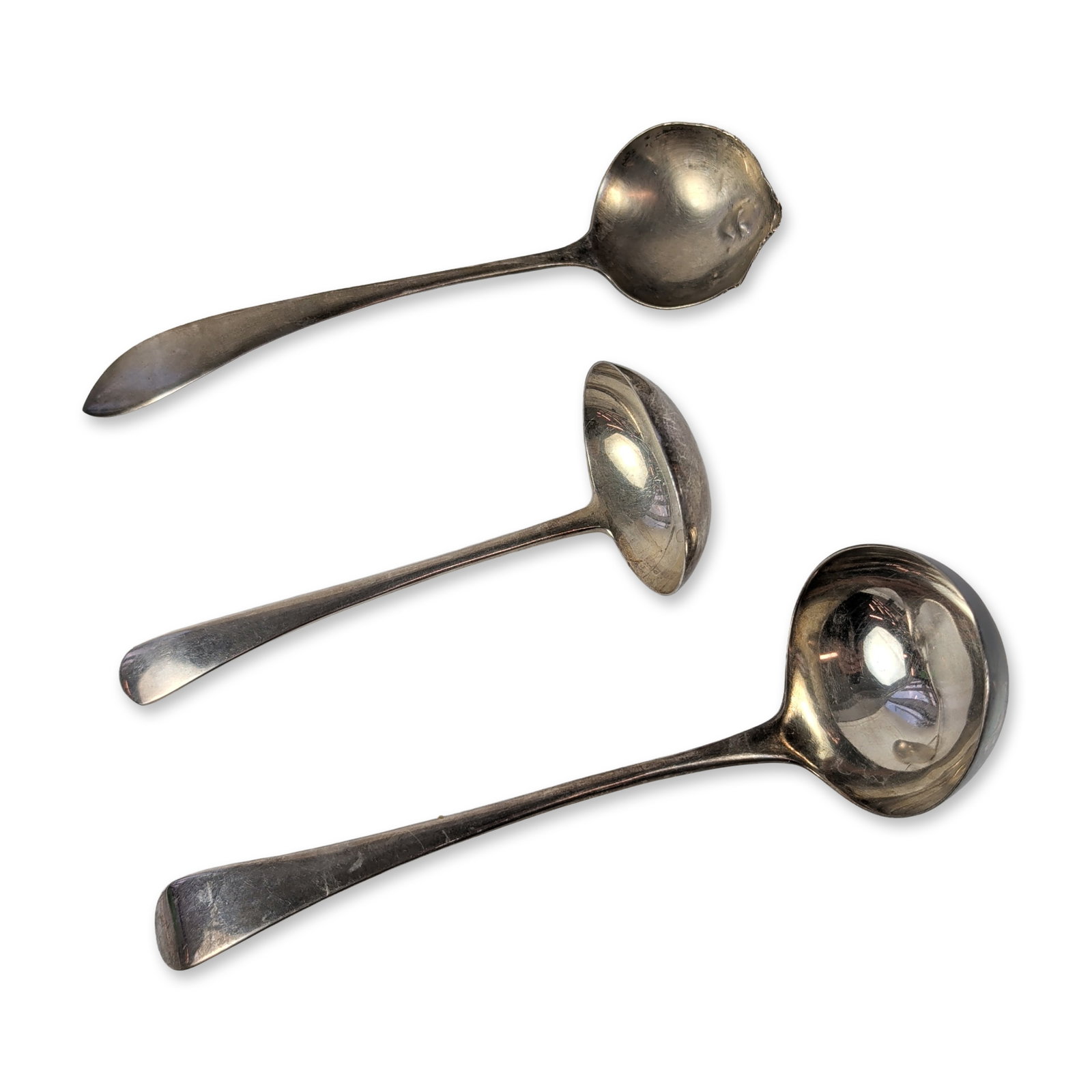 Trio of Sterling Silver Ladles includes Georg Jensen: This set features a Georg Jensen Inc. USA sterling silver sauce ladle with a double-ribbed stem and flared handle, stamped GEORG JENSEN INC U.S.A. and STERLING. It also includes a small sterling silve