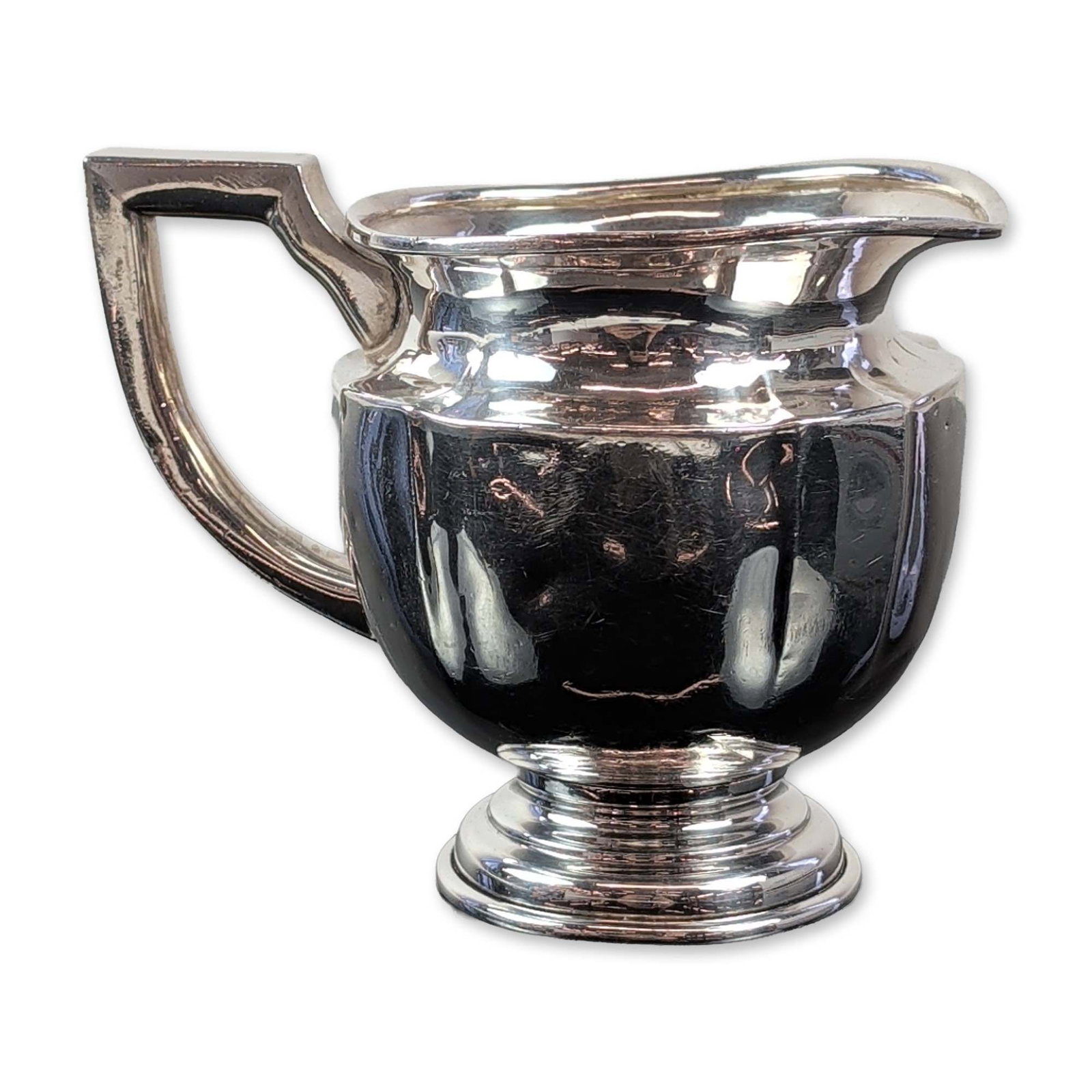 Art Deco Style 950 Sterling Silver Creamer: Art Deco style sterling silver creamer featuring a globular body and flared rim with an integral pouring spout. The piece is fitted with a distinctive geometric angular handle and is set upon a