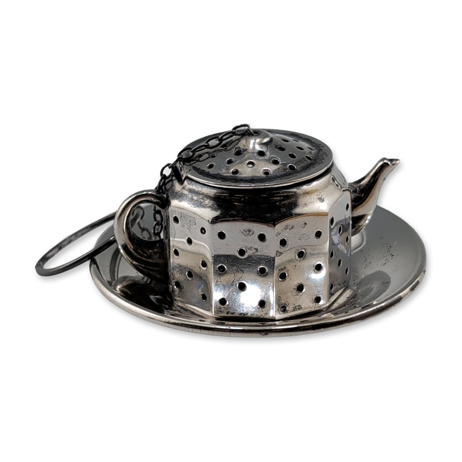 2pc Amcraft Sterling Silver Teapot Tea Infuser Set: American, mid-20th century, Amcraft teapot-form tea infuser and coordinating drip plate in sterling silver, featuring a faceted hexagonal body and hinged lid with fine perforations, fine-link chain,
