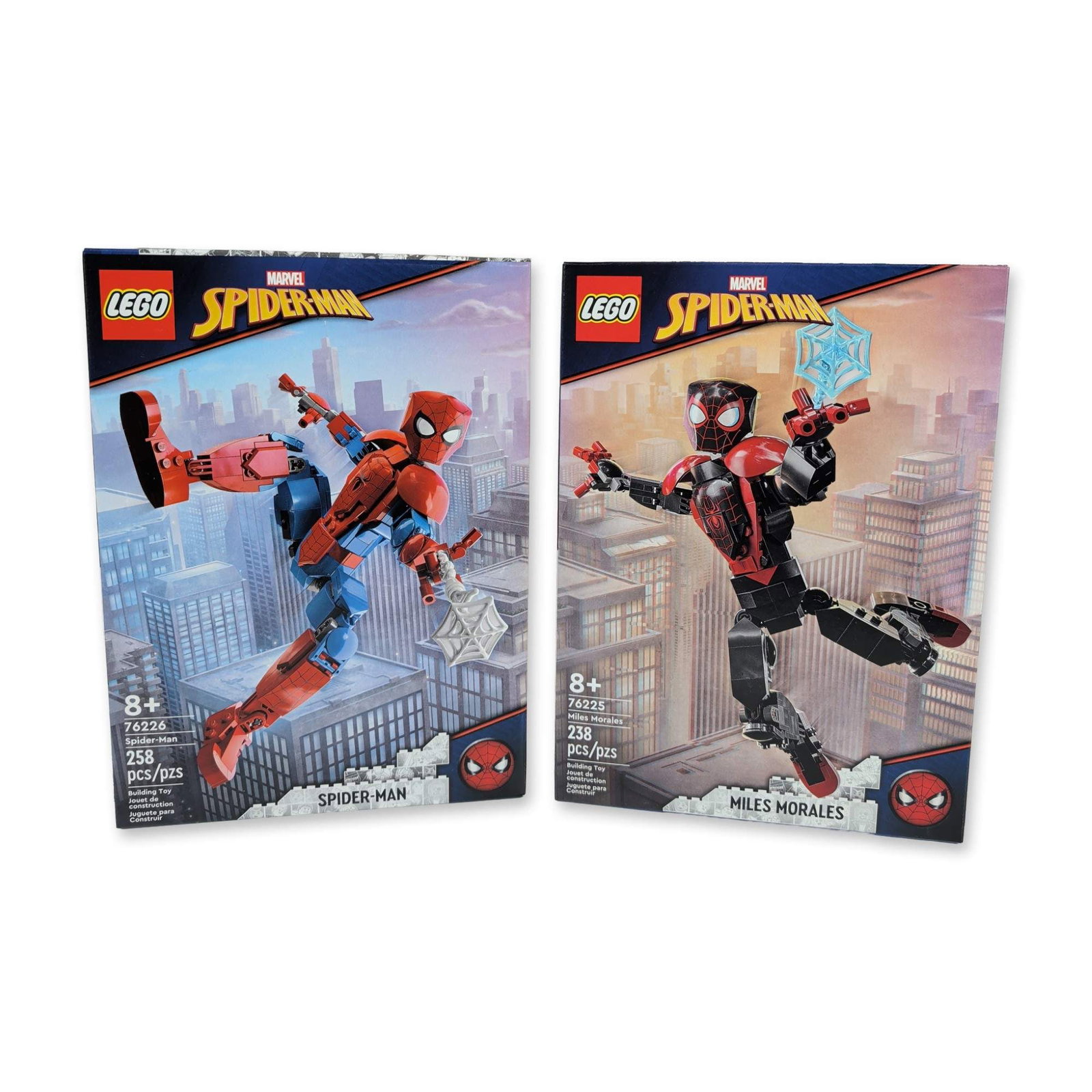 2 LEGO Spider-Man and Miles Morales Building Toys: The LEGO Group, circa 2022. Pair of Marvel Spider-Man buildable action figure construction sets in plastic. Includes set 76225 Miles Morales and set 76226 Spider-Man (Peter Parker). Each figure featur