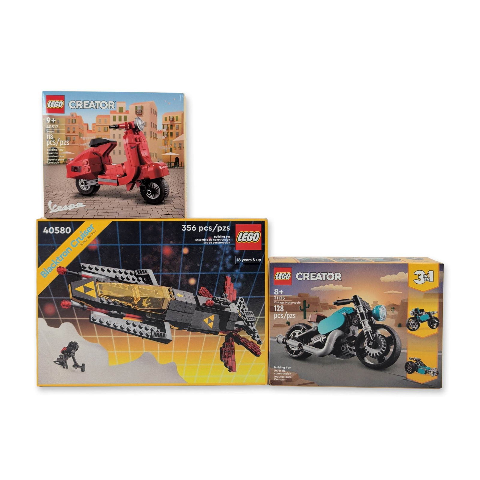 3pce LEGO Retro & Icons Collection: 1980s Blacktron Space, Classic Vespa & 3-in-1 Motorcycle: Three LEGO building sets in original factory packaging, featuring Creator and Space System themes. The grouping includes one LEGO Icons Blacktron Cruiser (Set 40580) comprised of 356 pieces, modeled