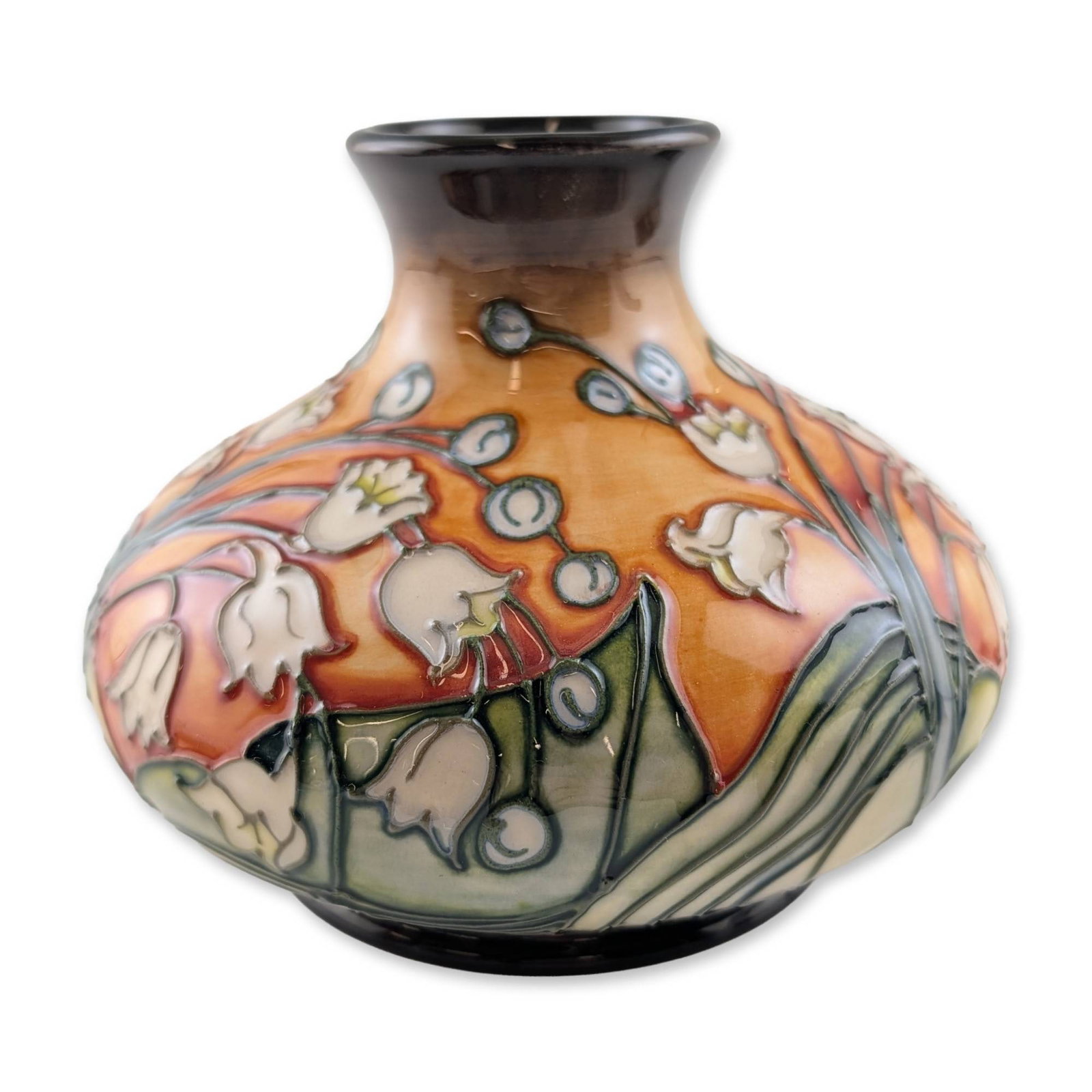 Moorcroft Lily of the Valley Limited Edition Ceramic Vase: Moorcroft pottery vase in the Lily of the Valley pattern, produced in Stoke-on-Trent, England. This squat, bulbous earthenware vessel features tubelined decoration with bell-shaped cream flowers and