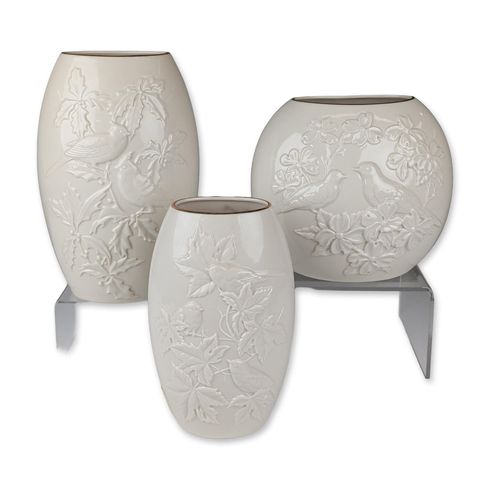 3pc Lenox Legacy Edition Seasonal Porcelain Vases: A set of three Lenox porcelain vases from the Seasonal collection, featuring high-relief molded botanical and avian motifs. The grouping includes a Spring vase depicting songbirds among fruit blossoms