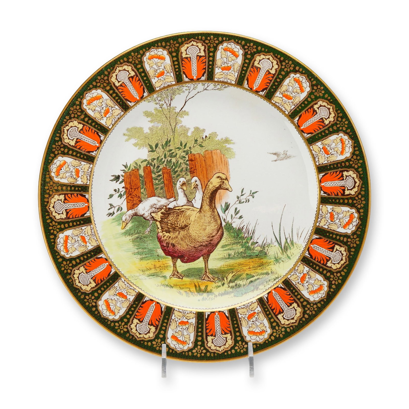 Wedgwood Etruria Earthenware Plate, Indian Pattern: The central well features a polychrome scene depicting three geese in a farmyard landscape; a large brown and tan goose stands in the foreground, while two white geese are positioned near a rustic woo
