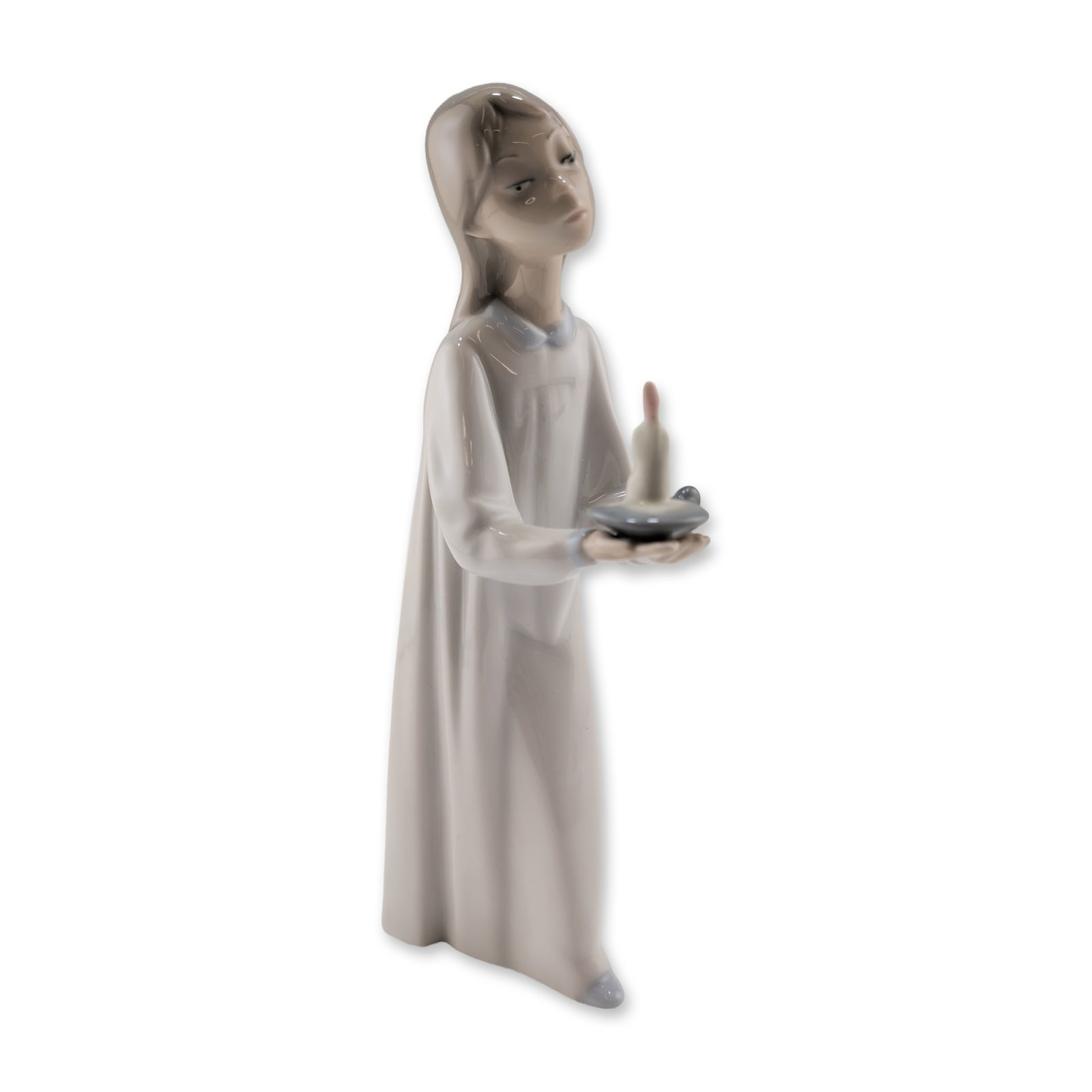Lladro Porcelain Figurine, Girl with Candle 01004868: Lladro (Spanish, 20th century). Figurine in glazed porcelain titled Girl with Candle (Nina con Palmatoria), designed by Fulgencio Garcia and first issued in the early 1970s. The piece depicts a standi