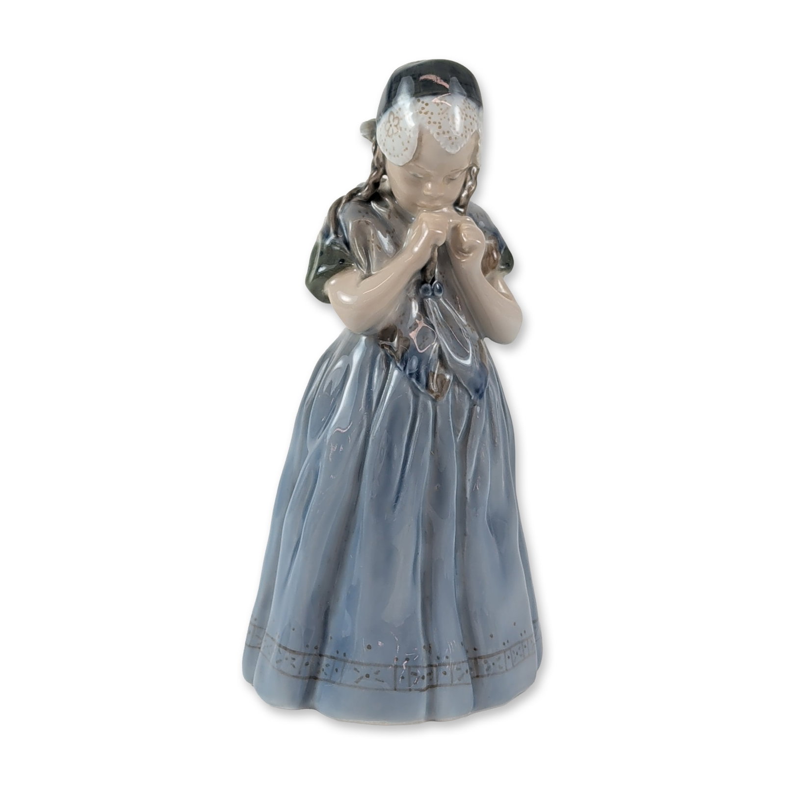 Royal Copenhagen Porcelain Bornholm Girl Figurine: Royal Copenhagen porcelain figurine titled Girl from Bornholm Isle, model number 1323, designed by artist Lotte Benter. The figure depicts a young girl in traditional Danish folk costume with clasped 