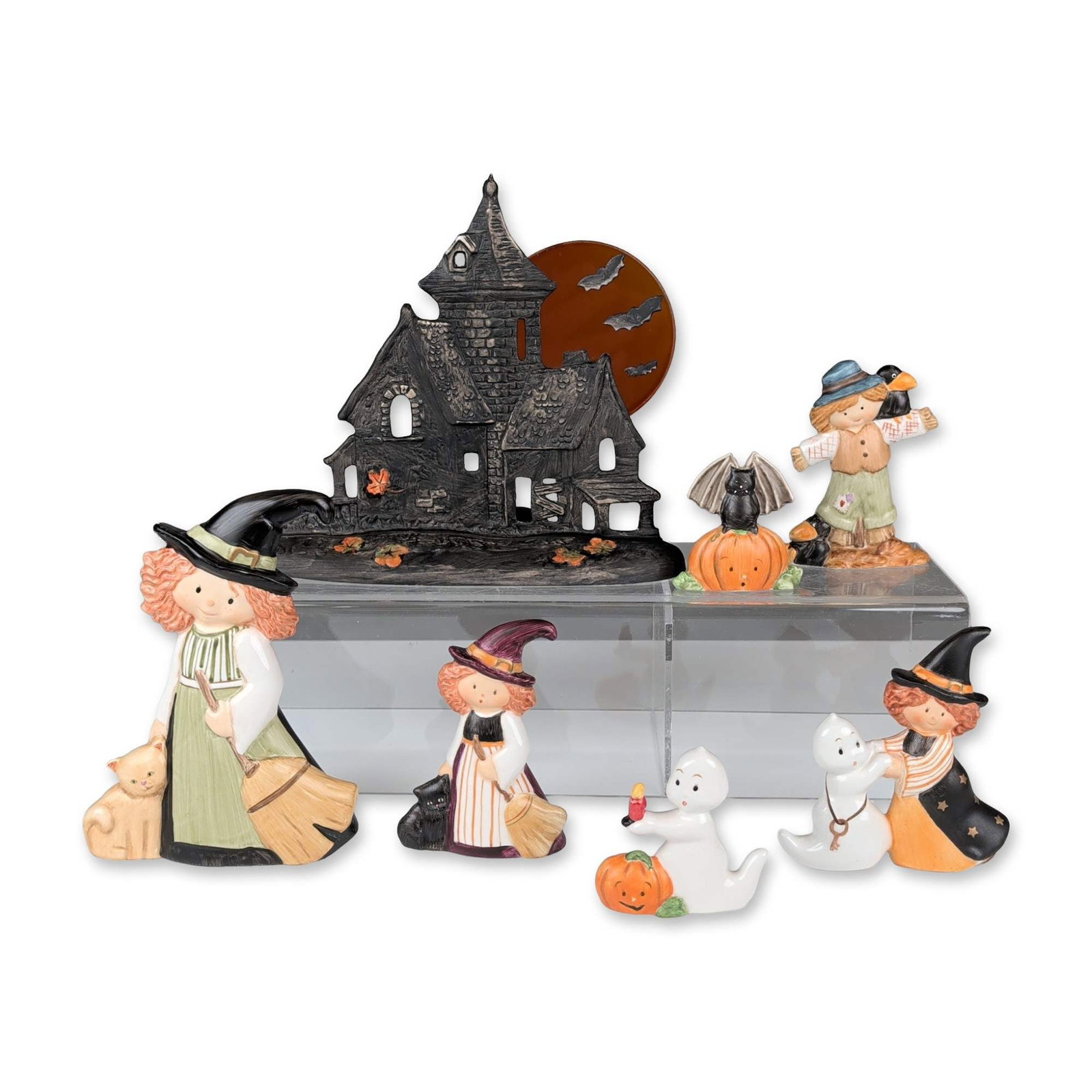 7pc Goebel Nordic Halloween Set and A Whiskery Witch Figurines: This Goebel Nordic Halloween collection consists of seven items featuring hand-painted ceramic figurines and a backdrop. The group includes a gothic-style haunted house with a translucent orange moon 