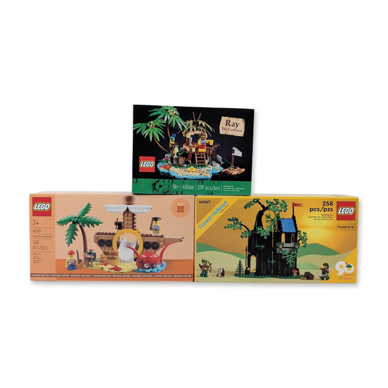 Three LEGO Building Sets - Ray The Castaway, Forest Hideout & Pirate Ship Playground: Group includes LEGO Ideas Ray the Castaway (40566) with 239 pieces, Forest Hideout (40567) 90 Years of Play commemorative set with 258 pieces, and Pirate Ship Playground (40589) with 168 pieces. Const