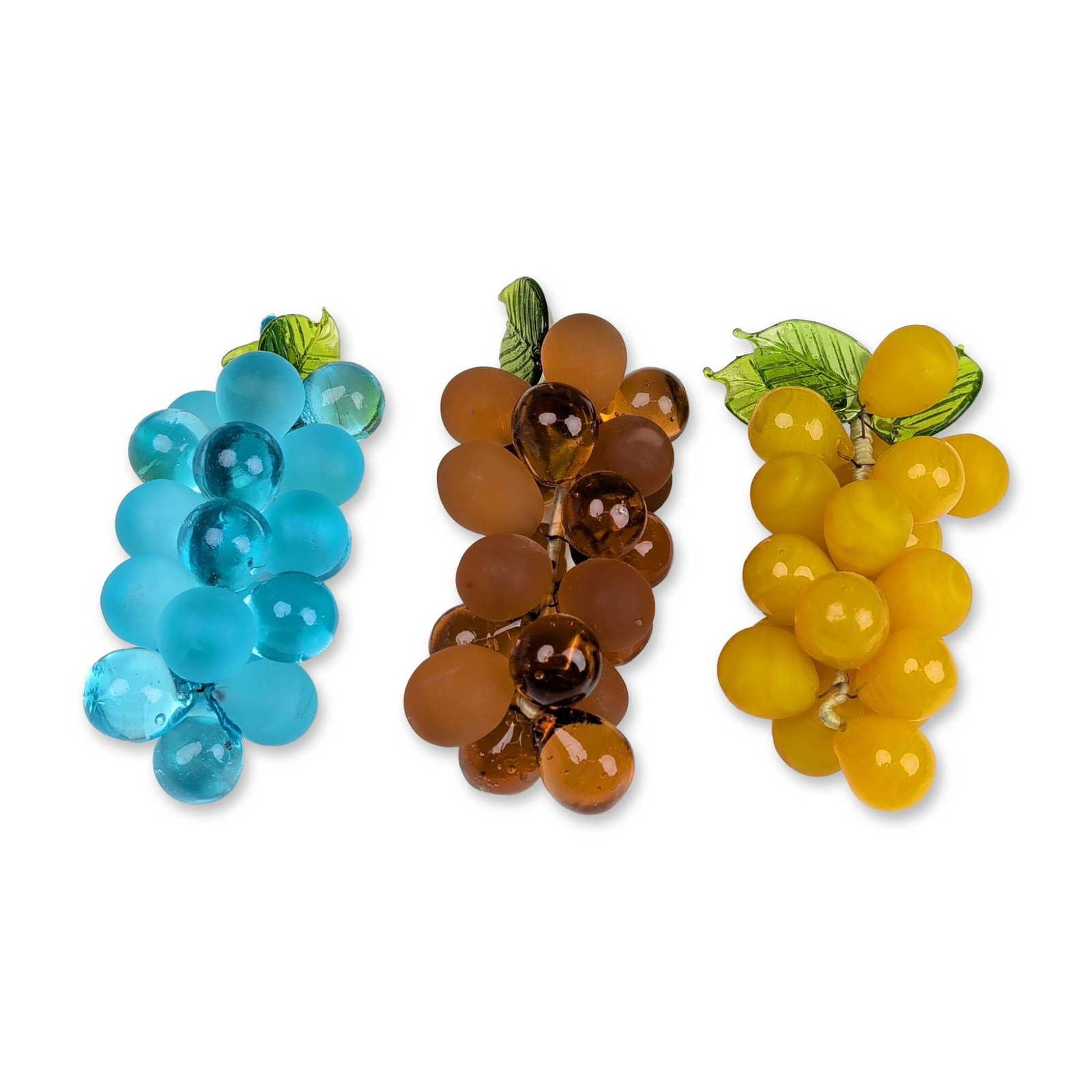 3pc Art Glass Grape Clusters: Set of three hand-assembled grape clusters in turquoise, amber, and yellow. The individual glass grapes feature varying finishes including frosted, translucent, and slag-style glass. Each bunch is fin