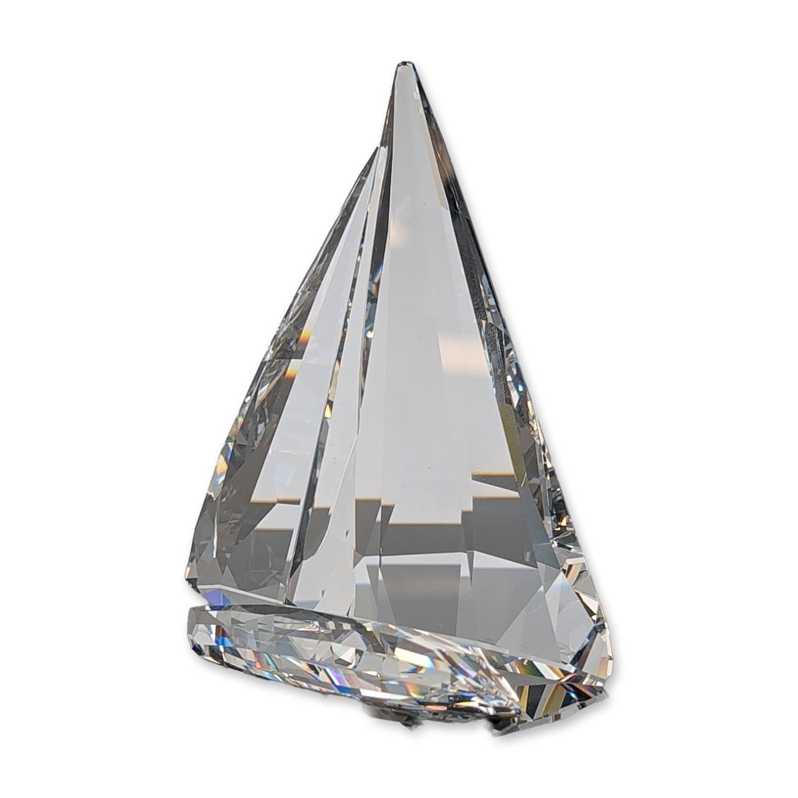 Swarovski Austrian Crystal Sailing Legend Sailboat Figurine: Swarovski stylized sailboat figurine in precision-cut clear crystal, featuring a modernist design with two interlocking faceted sections. The aerodynamic form exhibits sharp geometric lines and prisma