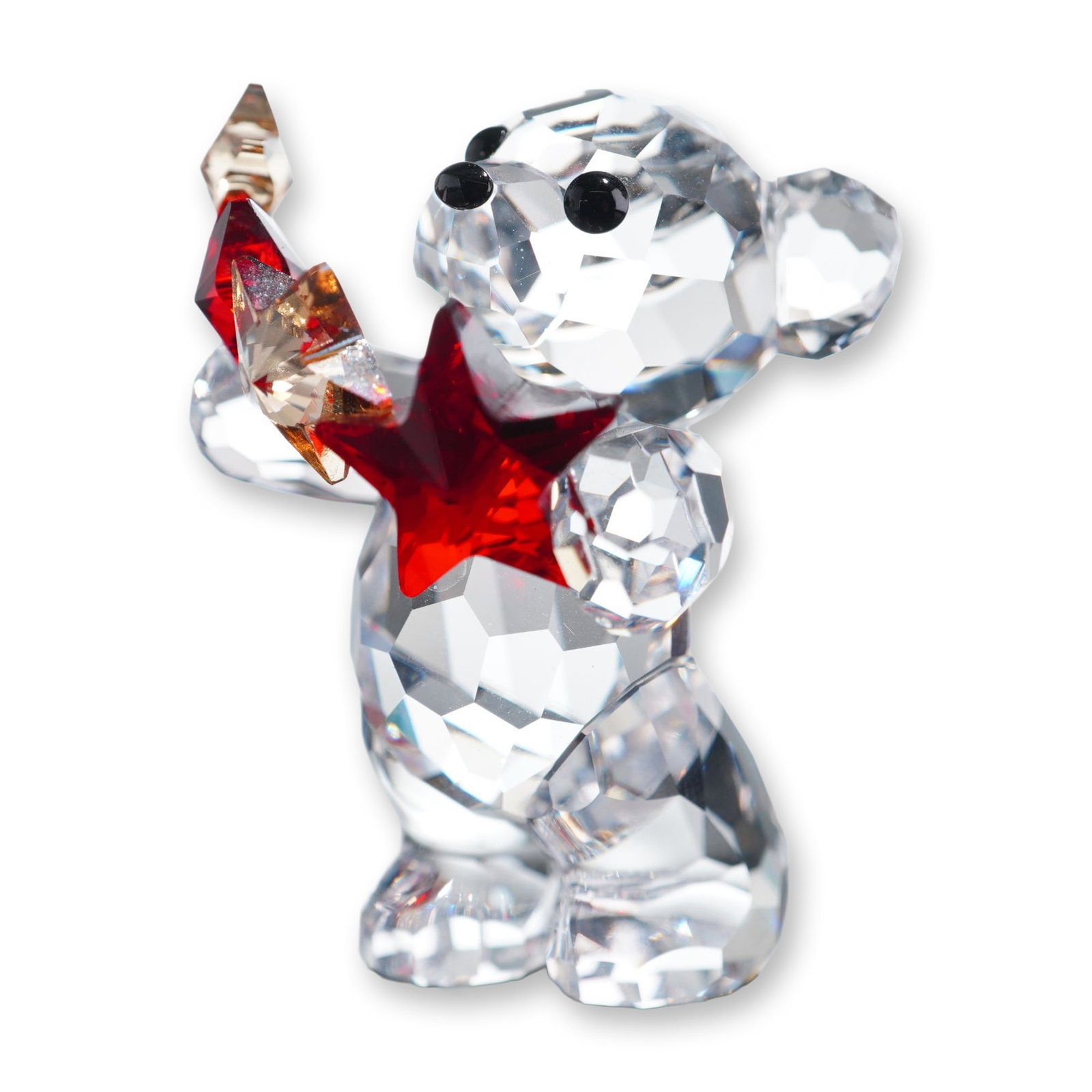 Swarovski Crystal 2009 Annual Edition Figurine, Kris Bear Christmas: Swarovski, Austria. Kris Bear series figurine in faceted lead crystal, depicting a standing bear holding a red star and a golden amber star. Features black crystal eyes and nose. Marked with an etched