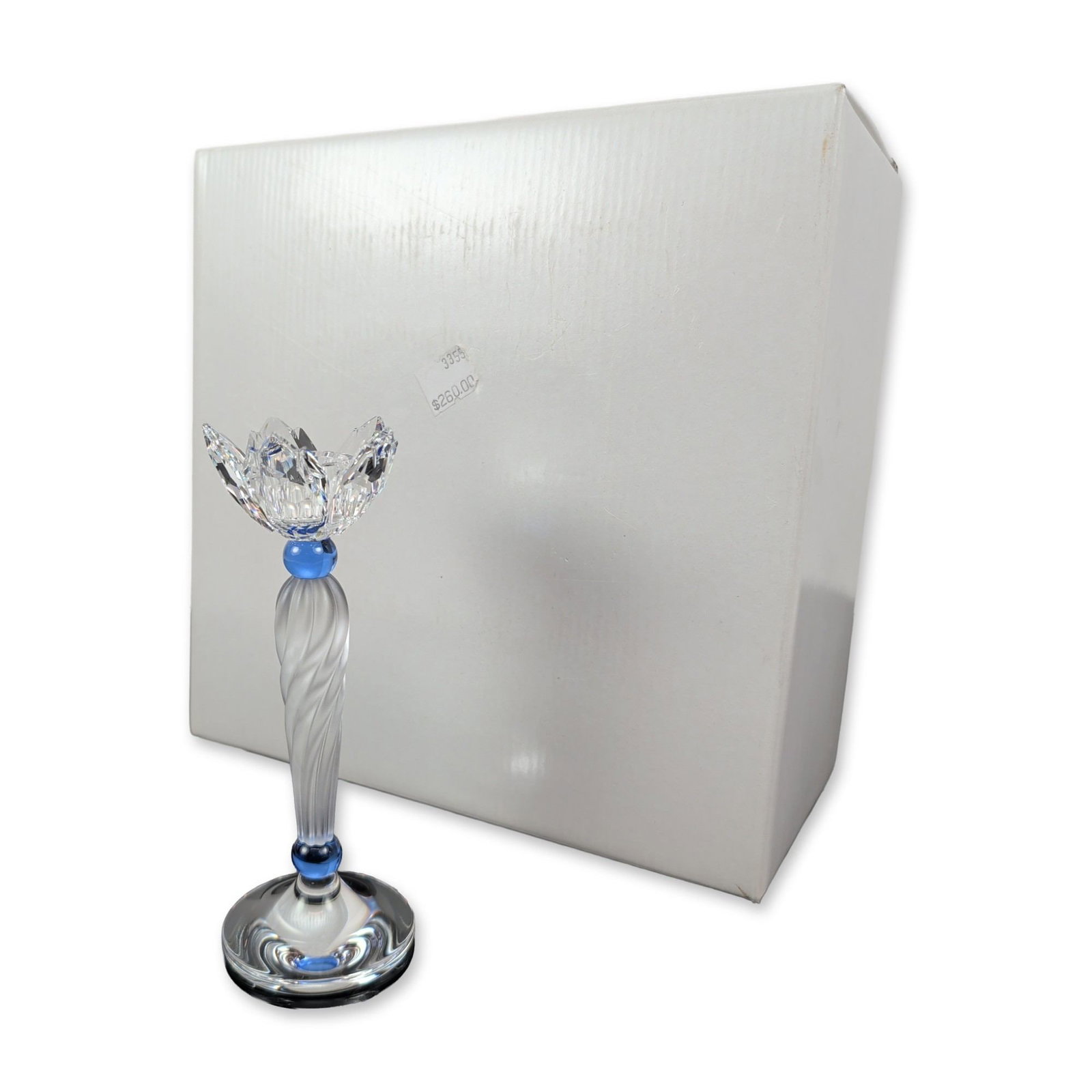 Swarovski Crystal Blue Flower Candleholder: Swarovski crystal candleholder designed by Gabriele Stamey, featuring a faceted clear crystal lotus-form cup and a frosted crystal spiral stem. The stem is accented by two cobalt blue crystal spheres 