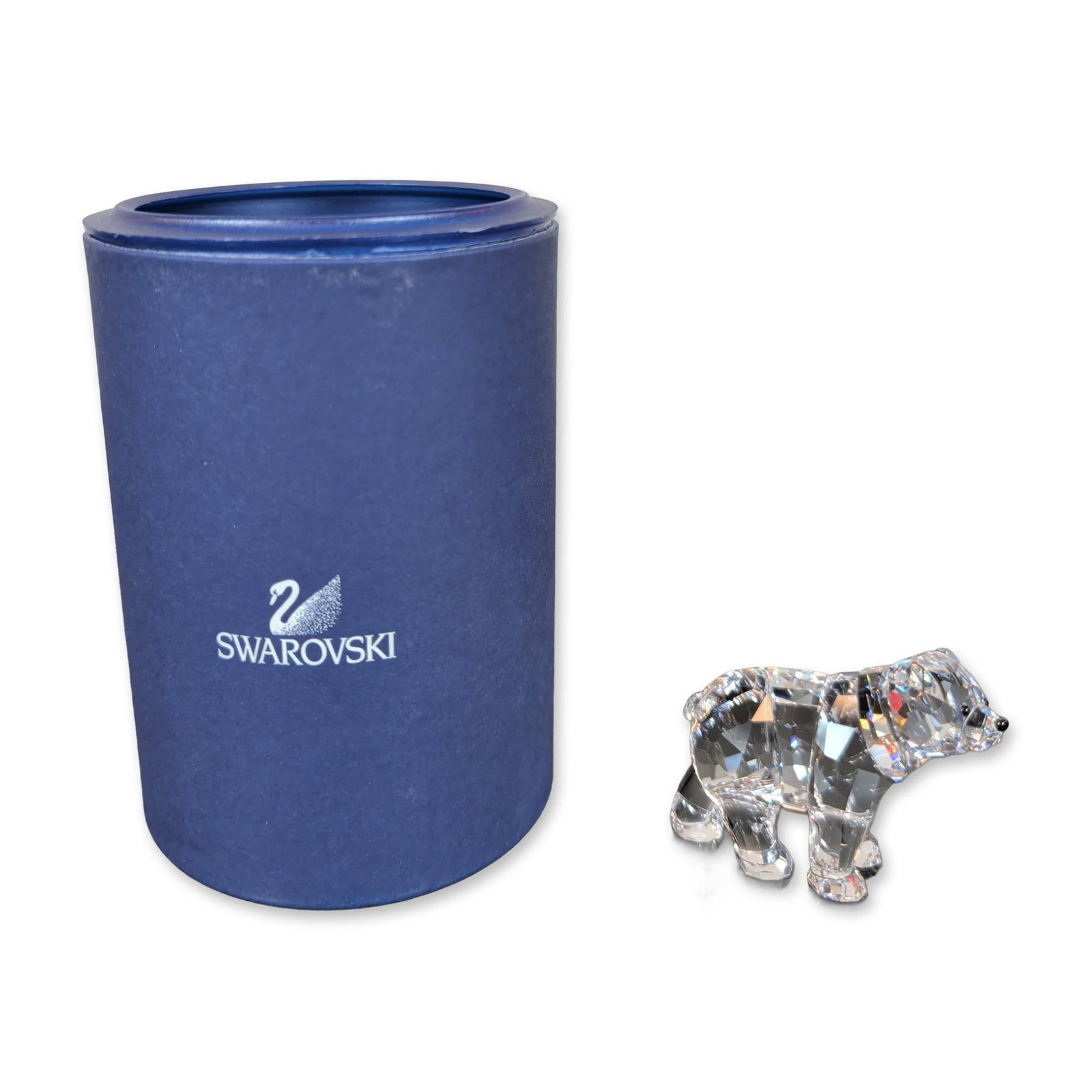 Swarovski Crystal Brother Bear Figurine with Box: The piece features jet crystal accents for the eyes and nose. The underside of one foot is marked with an etched stylized swan hallmark. Accompanied by the original blue cylindrical presentation box w