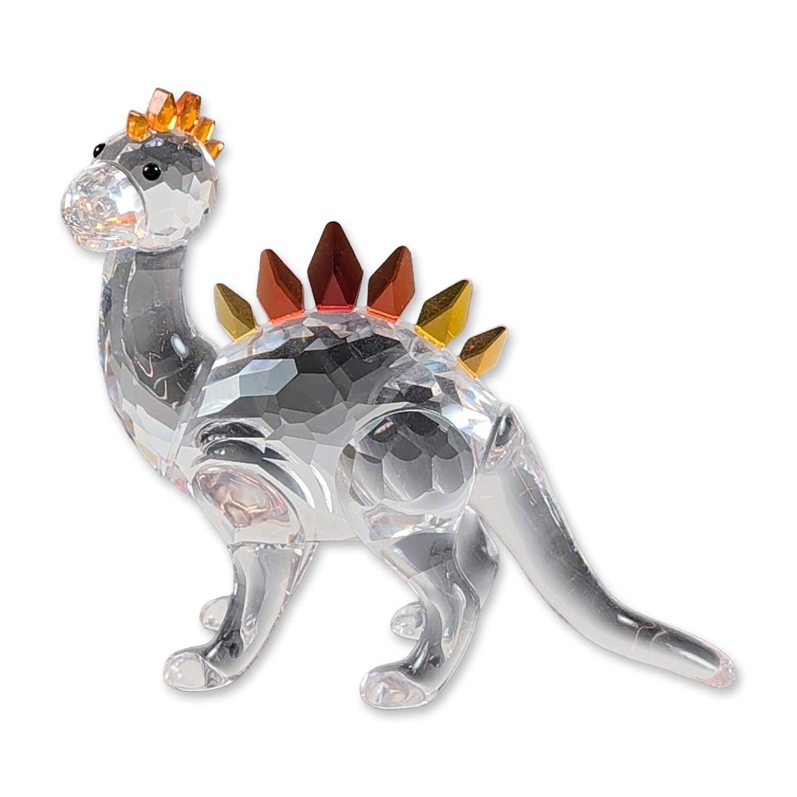Swarovski Crystal Dino Dinosaur Figurine: Swarovski crystal figurine of a dinosaur, model number 268204 from the Fables and Fairy Tales collection. The piece is constructed with a central faceted clear crystal body and smooth molded clear cry