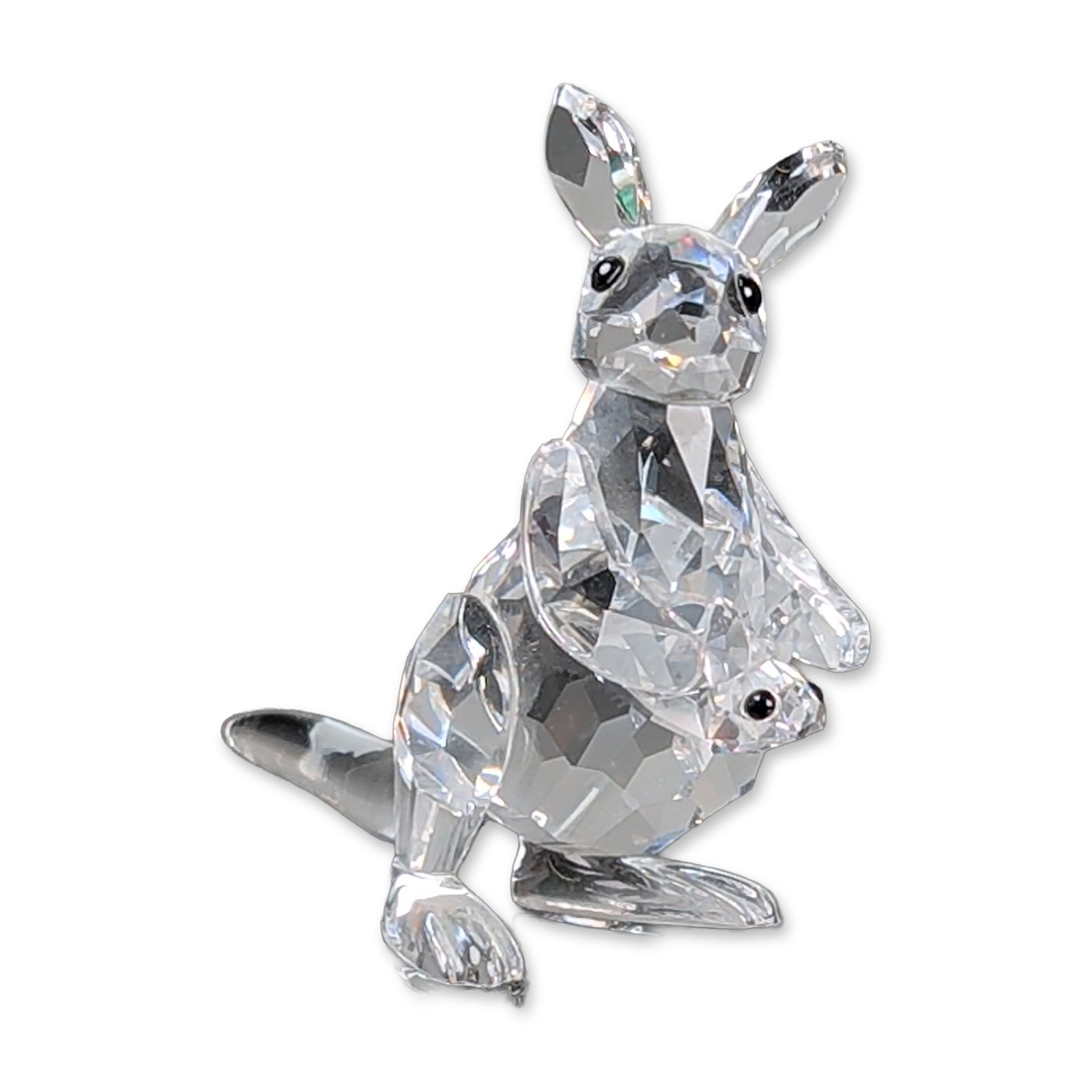 Swarovski Crystal Figurine, Kangaroo with Baby Joey: Swarovski faceted lead crystal figurine depicting a kangaroo with a joey in its pouch. The figures feature multi-faceted bodies, heads, and limbs, accented by smooth, unfaceted curved tails and small 