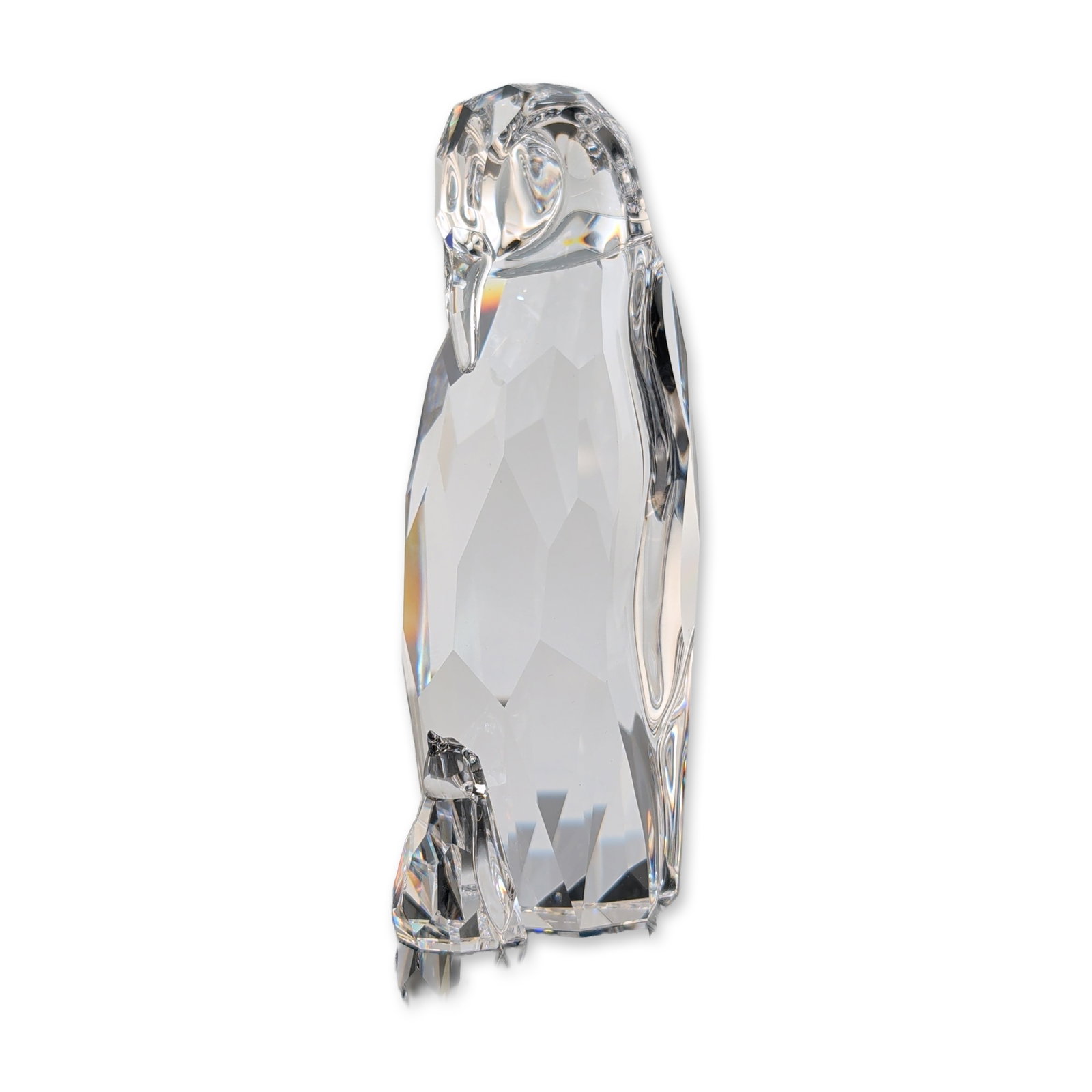 Swarovski Crystal Mother Penguin and Baby Figurine: Swarovski figurine in clear faceted lead crystal, featuring a mother penguin with a lowered head, looking down at her baby in front of her. Etched swan logo and copyright symbol on the base. Accompani