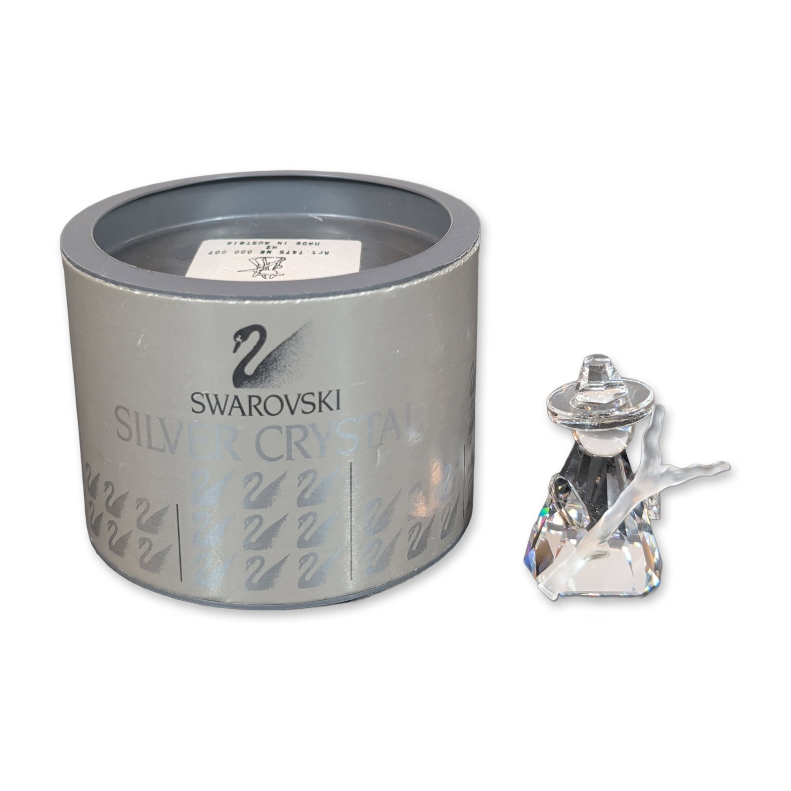 Swarovski Crystal Nativity Shepherd Figurine: Swarovski Crystal Nativity Shepherd. The figure features a faceted crystal head and body with a wide-brimmed hat, while the outstretched arms and supporting post are rendered in frosted crystal. The b