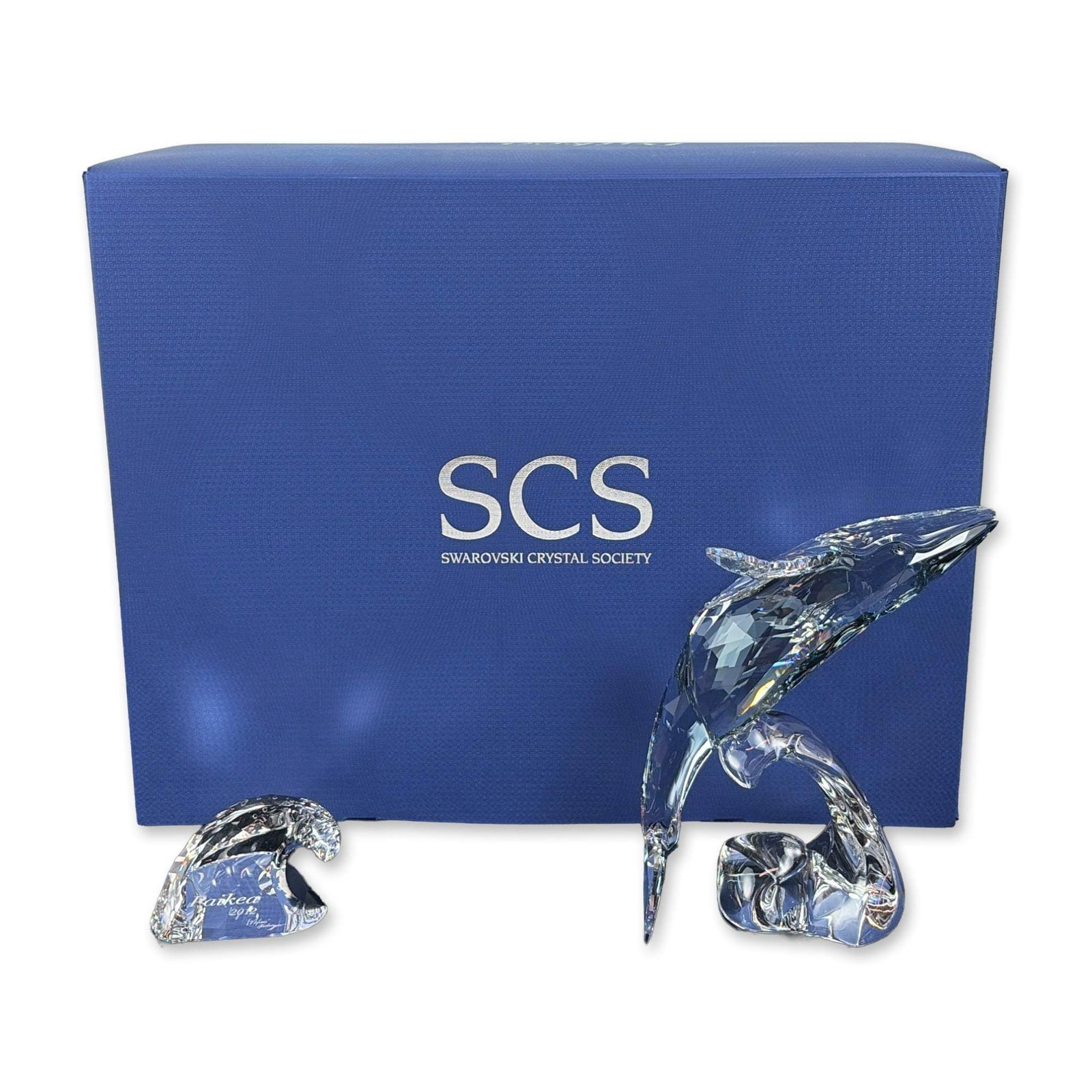 Swarovski Crystal Paikea Whale Figurine and Plaque: This charming young whale sparkles in Shadow crystal with Crystal Moonlight fins, depicting a humpback whale alongside a separate stylized wave plaque. Released as the Swarovski Crystal Society (SCS) 