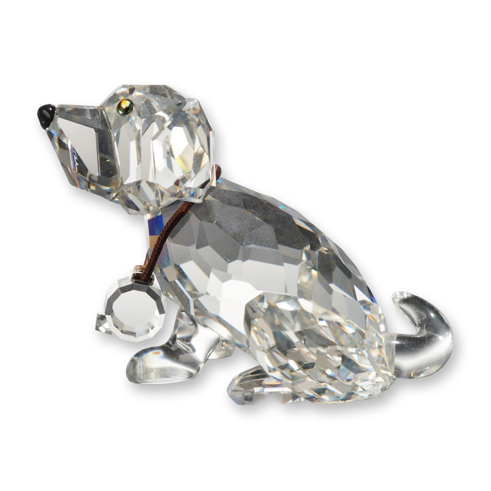 Swarovski Crystal St. Bernard Puppy Figurine: Swarovski Silver Crystal figurine of a St. Bernard puppy in faceted clear lead crystal. The figure is modeled in a seated position with amber-toned eyes and a black crystal nose. It features a brown c