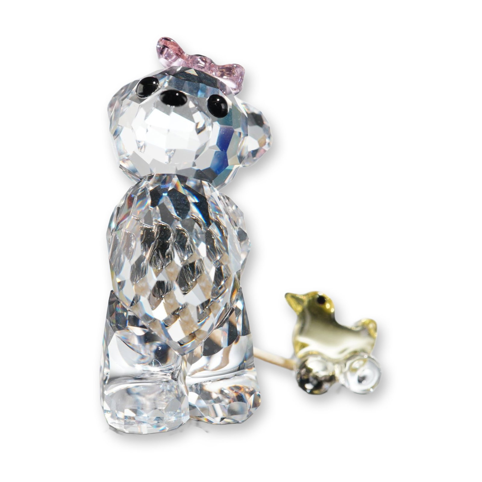 Swarovski Kris Bear Its a Girl Crystal Figurine: Swarovski crystal figurine from the Kris Bear collection, titled It's a Girl! The piece is constructed from faceted lead crystal, depicting a bear with black crystal eyes and nose wearing a small pink