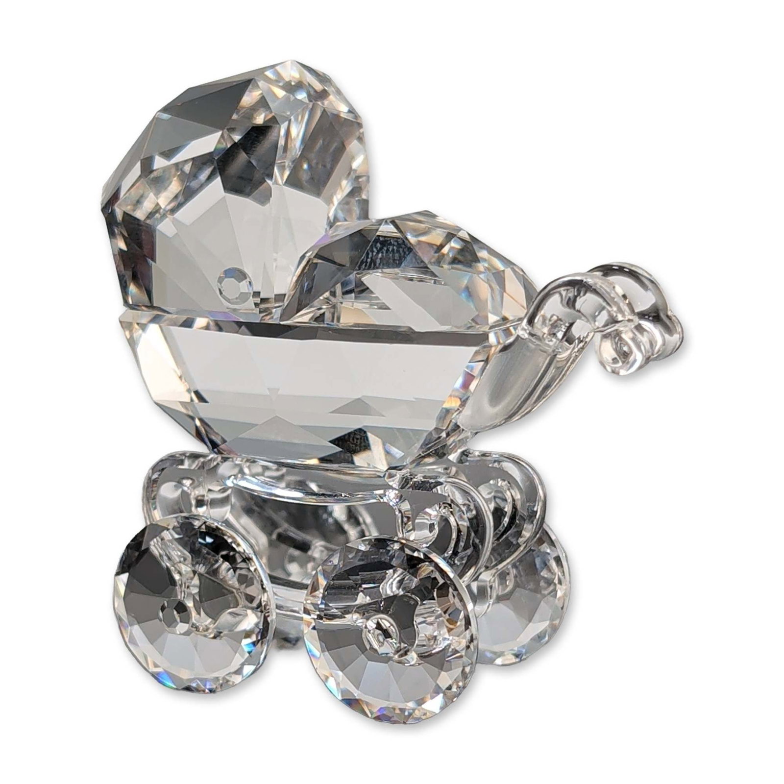Swarovski Silver Crystal Faceted Baby Carriage: Swarovski Silver Crystal baby carriage figurine in faceted clear lead crystal. The construction features a main body formed from two large multifaceted crystals, a curved crystal handle, and four smal