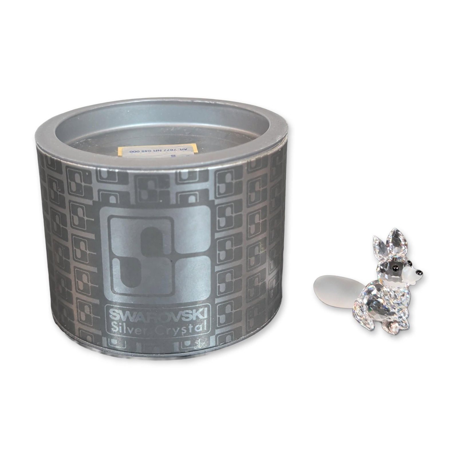 Swarovski Silver Crystal Figurine, Mini Sitting Fox: Figurine in faceted and frosted lead crystal, featuring a clear faceted body, frosted snout and tail, and black bead accents for the eyes and nose. Identification label on original cylindrical retail 