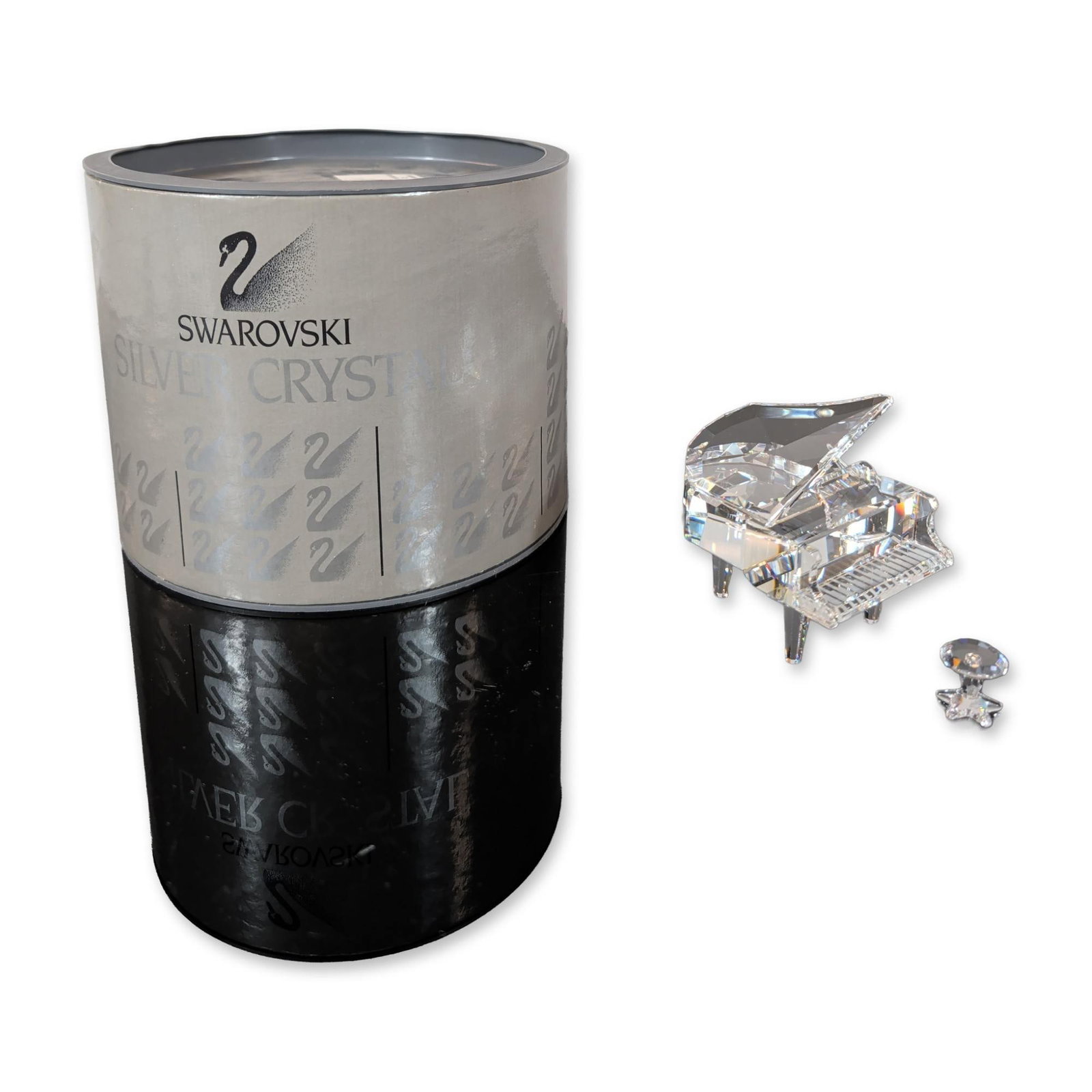 Swarovski Silver Crystal Grand Piano and Stool: Swarovski Silver Crystal grand piano and stool from the Musical Instruments series. This set is crafted from faceted clear lead crystal. The piano features an open lid supported by a slender prop and 