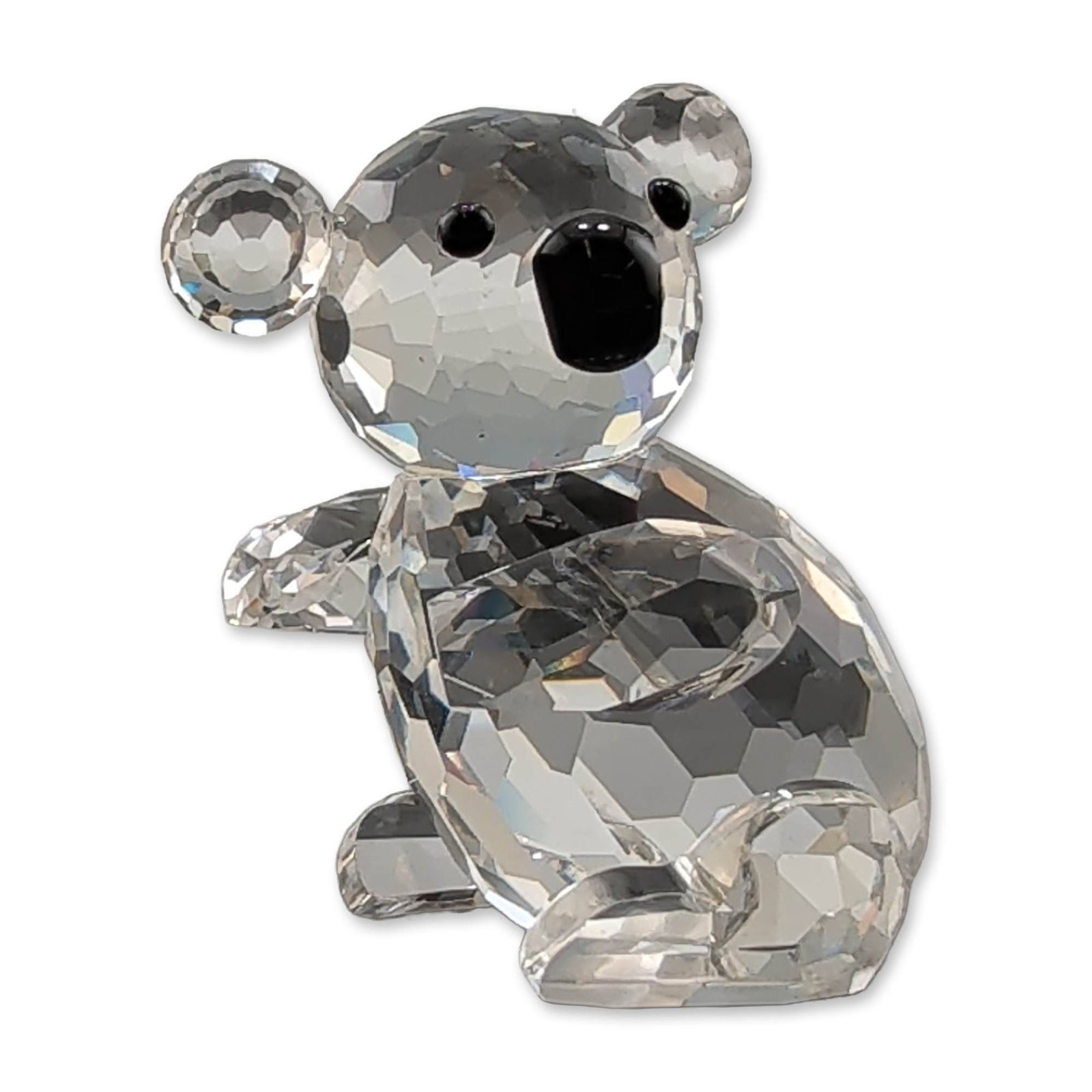 Swarovski Silver Crystal Koala Figurine: Swarovski Silver Crystal faceted clear lead crystal figurine in the form of a koala. The piece features a faceted body and head with rounded ears and four small limbs. The face is detailed with two bl