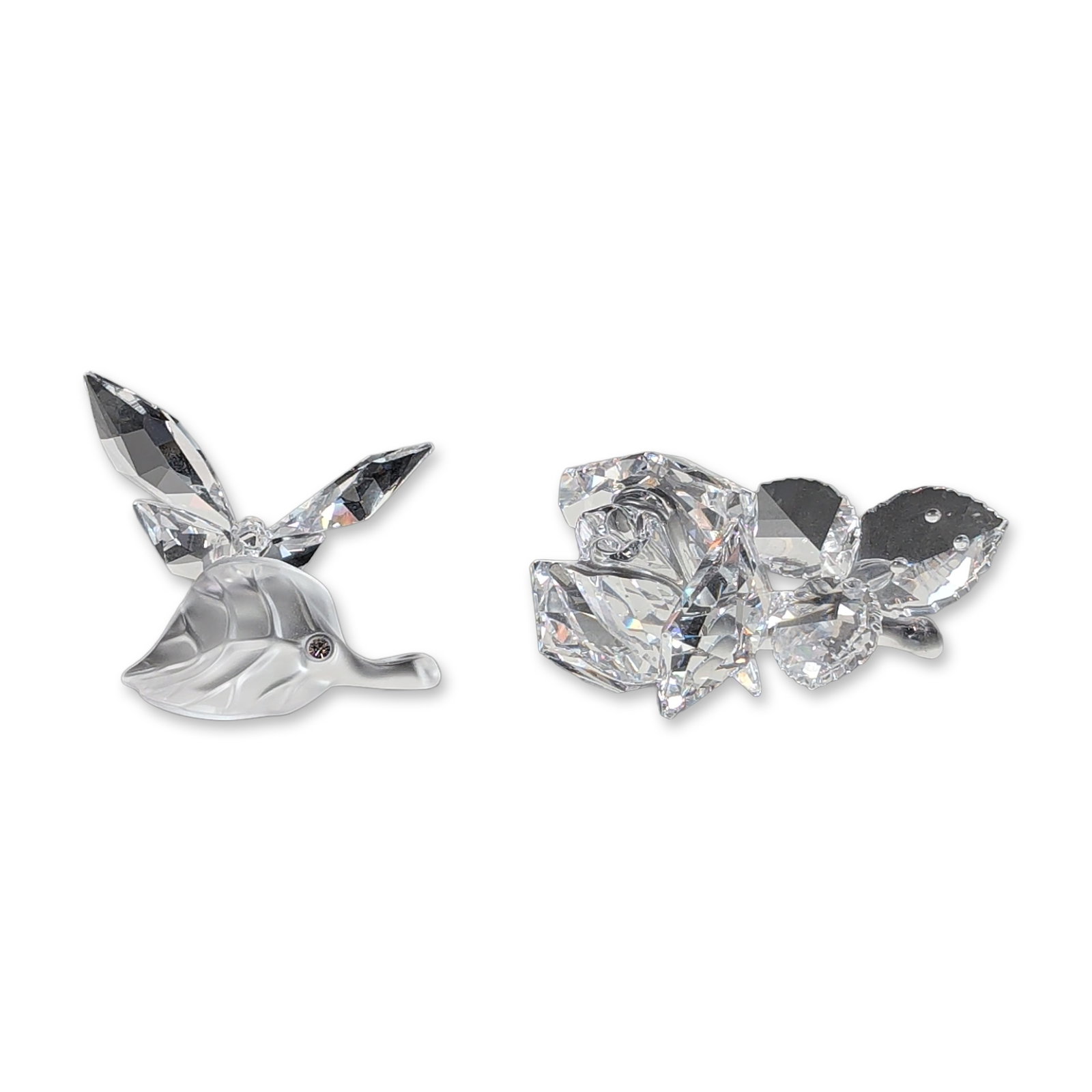 2pc Swarovski Crystal Rose and Butterfly on Leaf Figurines: Swarovski presents two charming crystal figurines: a faceted rose and a butterfly on a leaf. The rose showcases a sparkling crystal bloom on a smooth stem with two faceted leaves, while the butterfly 