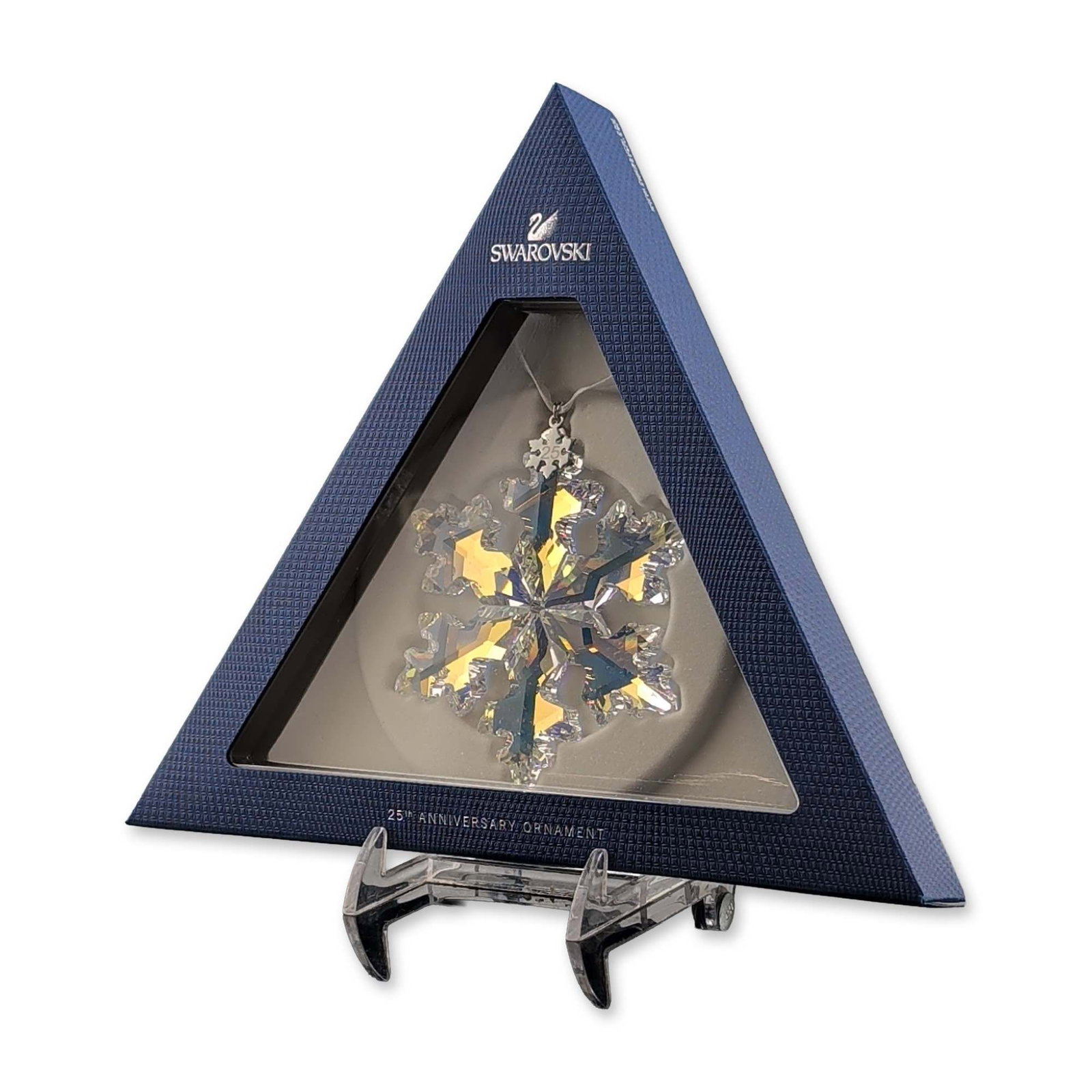 Swarovski 25th Anniversary 2016 Limited Edition Crystal Ornament: Swarovski. Snowflake ornament in faceted lead crystal with an Aurora Borealis (AB) iridescent coating, commemorating the 25th anniversary of the Swarovski Annual Edition series. The piece features a m
