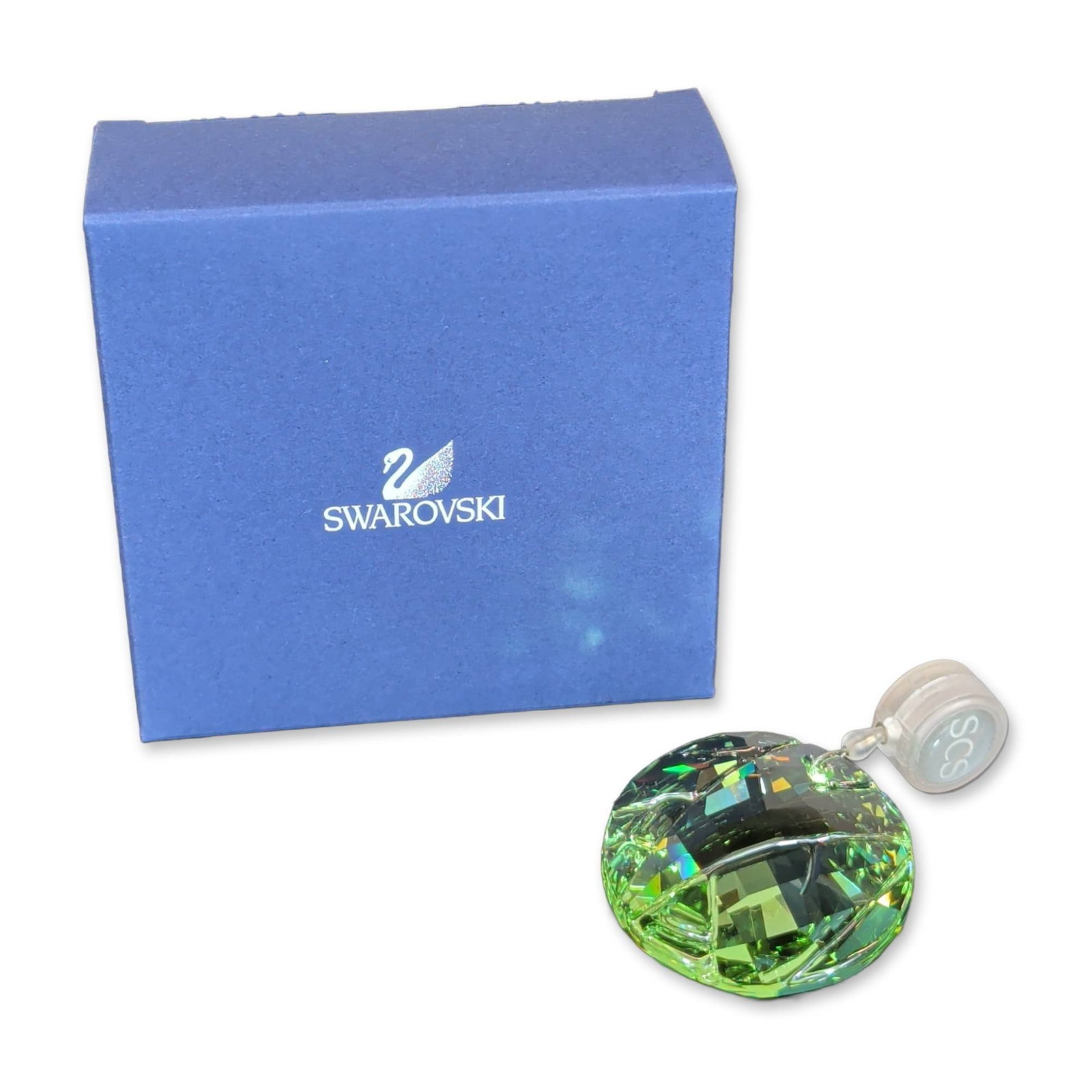 Swarovski SCS Green Bamboo Window Suncatcher: Swarovski Crystal Society (SCS) faceted lead crystal ornament in transparent green. The circular piece features an etched stylized bamboo motif to the front surface. Accompanied by the original blue S