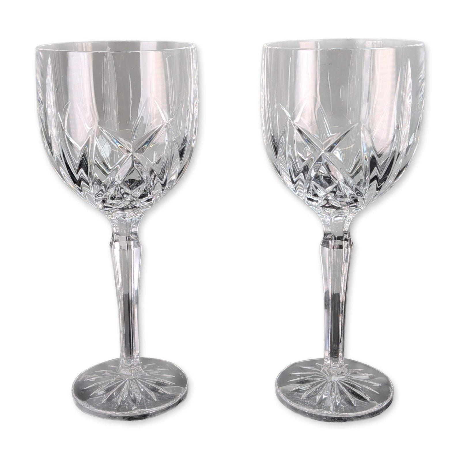 Pair of Marquis by Waterford Brookside Crystal Goblets: Marquis by Waterford. Pair of wine goblets in lead crystal, in the Brookside pattern. Each piece features a bowl decorated with vertical wedge cuts over a lower band of crisscross diamond cuts, a face