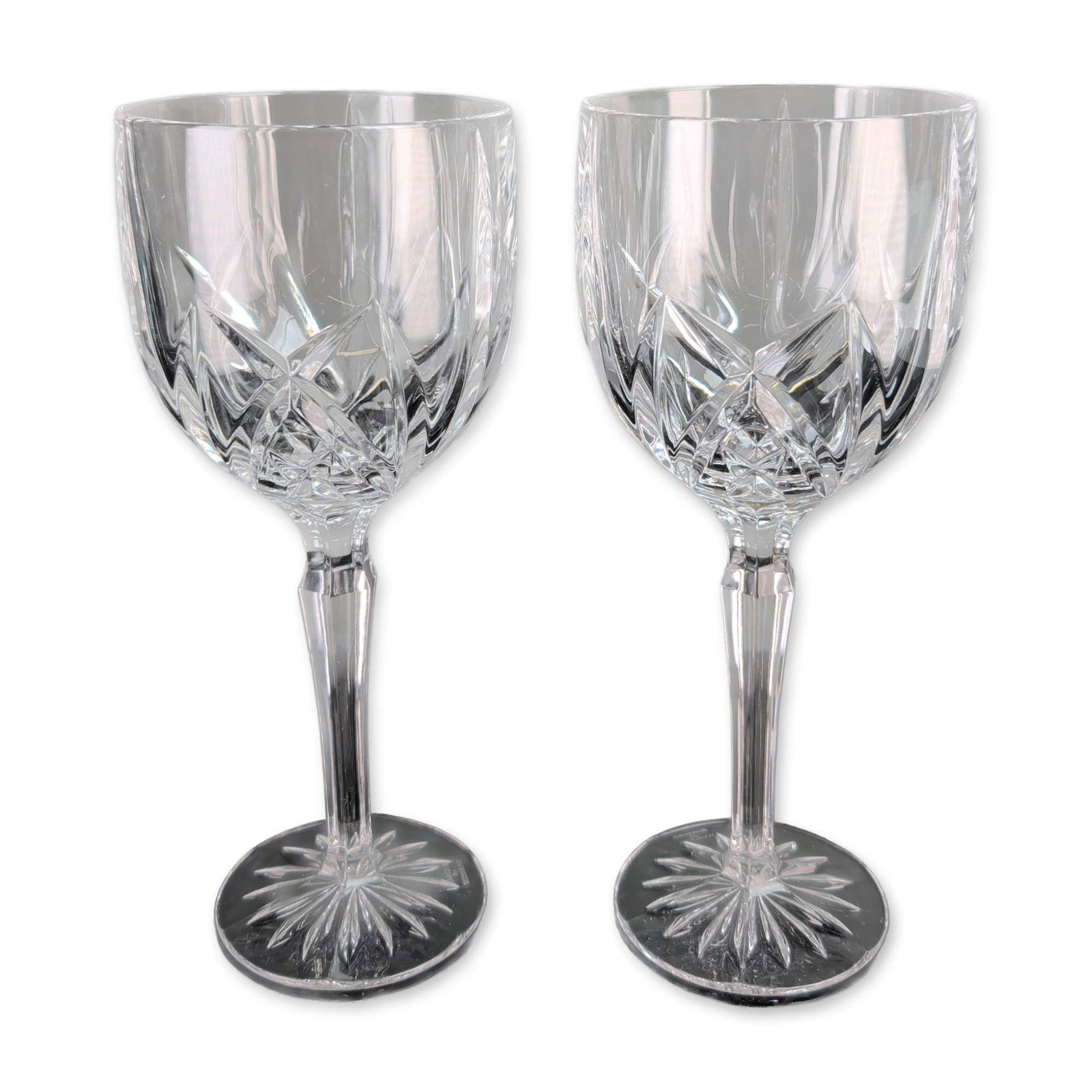 Pair of Marquis Waterford Brookside Crystal Goblets: Marquis by Waterford. Pair of wine goblets in clear crystal, featuring the Brookside pattern with deep-cut crisscross diamond and vertical wedge motifs. Each glass has a faceted hexagonal stem and a c