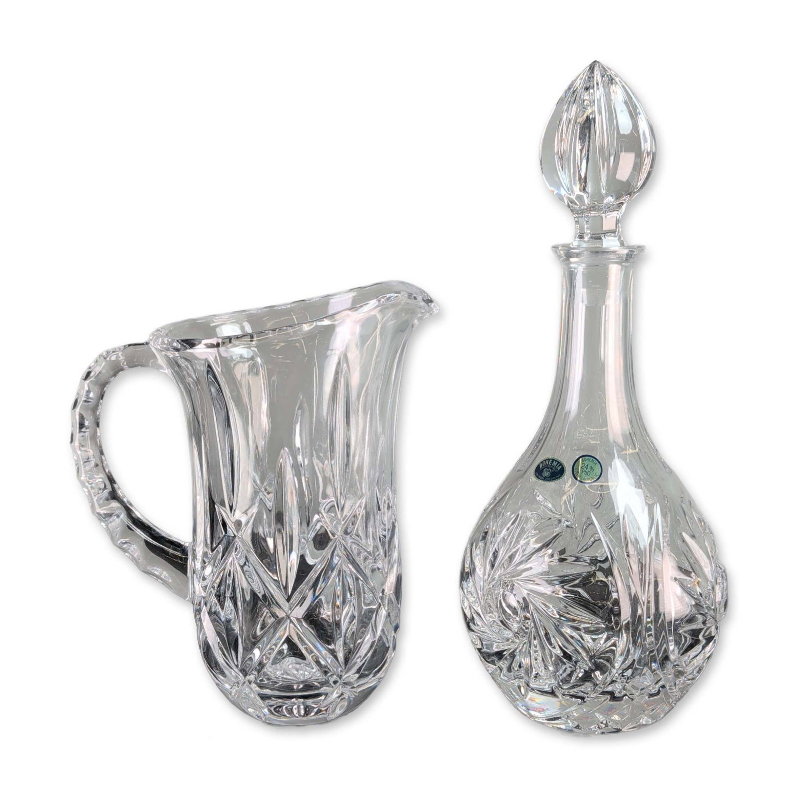 2pc Bohemia Czech Cut Lead Crystal Decanter and Pitcher: Bohemia Crystal (Czech Republic) decanter and pitcher set in 24 percent lead crystal. The bulbous-form decanter features a hand-cut pinwheel motif accented by vertical mitre cuts and diamond cross-hat