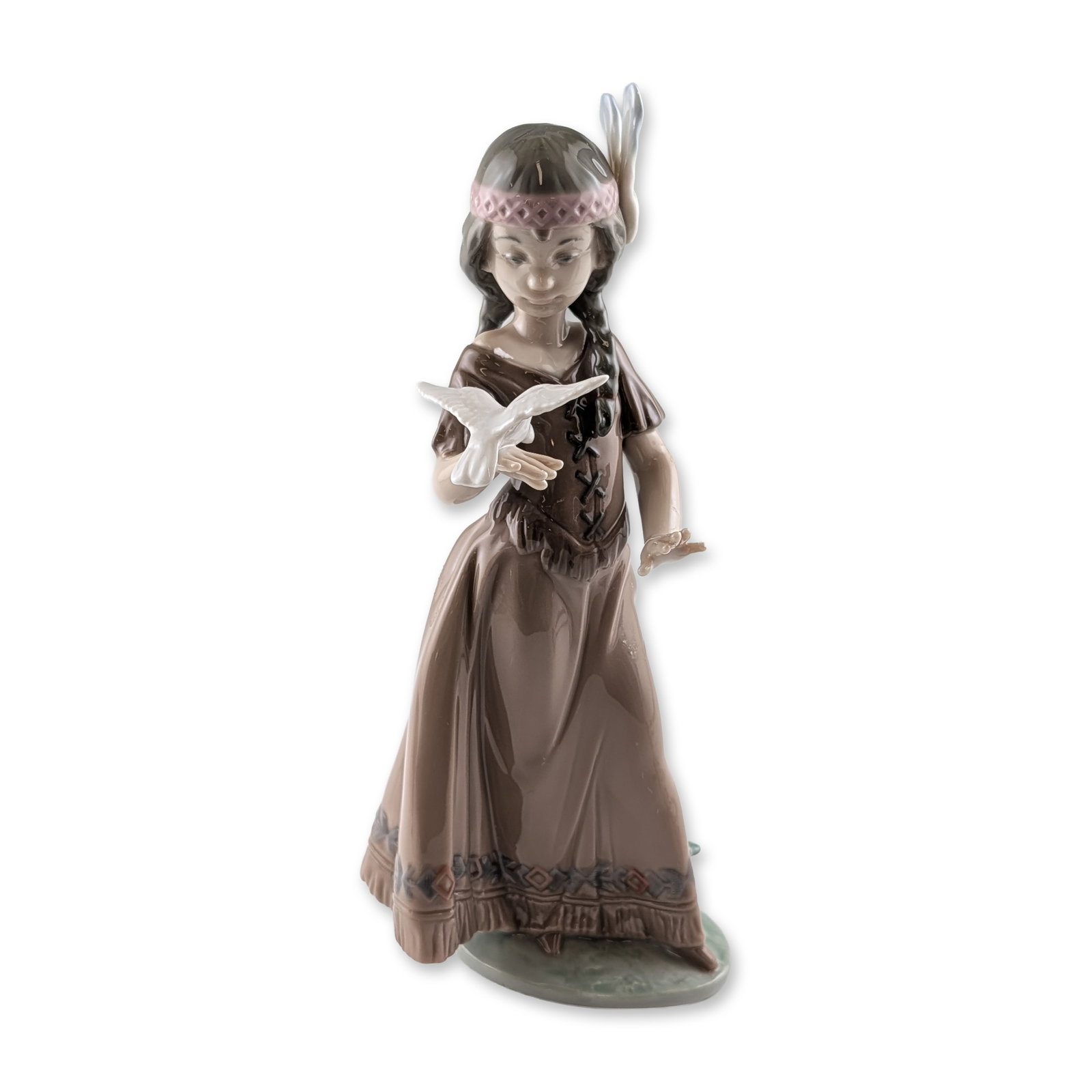Lladro American Love Porcelain Figurine 6153: Spanish Lladro glazed porcelain figurine titled American Love, model number 6153, designed by sculptor Antonio Ramos. The piece depicts a young Native American girl in a brown fringed dress with a geo