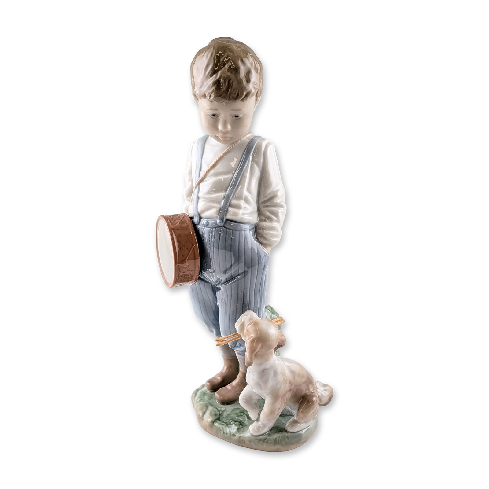 Lladro Friendly Duet Porcelain Figurine, Signed: Lladro (Spain). Figurine in glazed porcelain, model number 6846, titled Friendly Duet. The composition depicts a young boy in a white shirt and blue striped trousers with suspenders standing beside a 