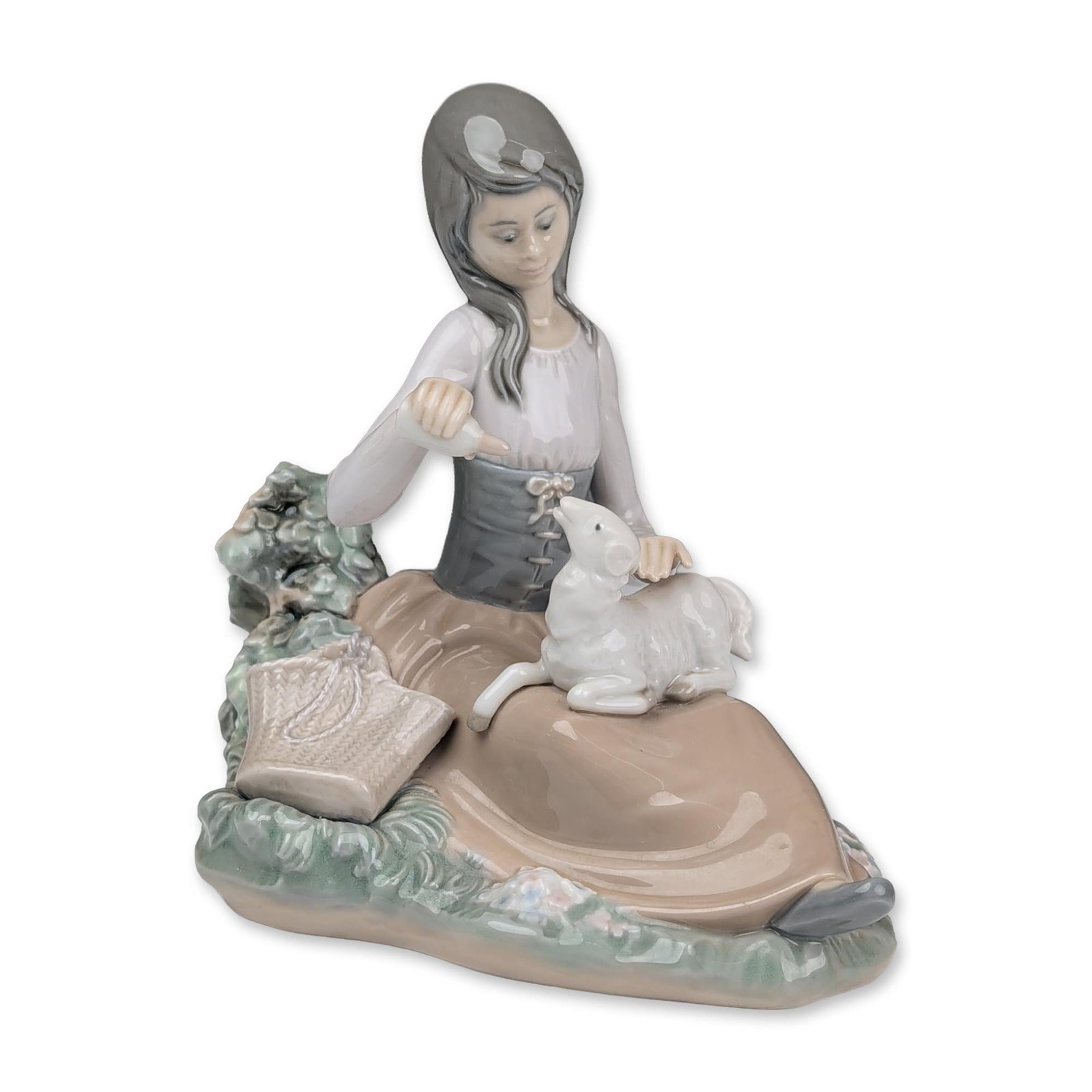 Lladro Porcelain Figurine, Little Bo Peep 01001312: Lladro (Spanish, 20th century). Glazed porcelain figurine titled Little Bo Peep, model number 1312, designed by Jose Roig. The piece depicts a seated shepherdess feeding a white lamb from a bottle, si