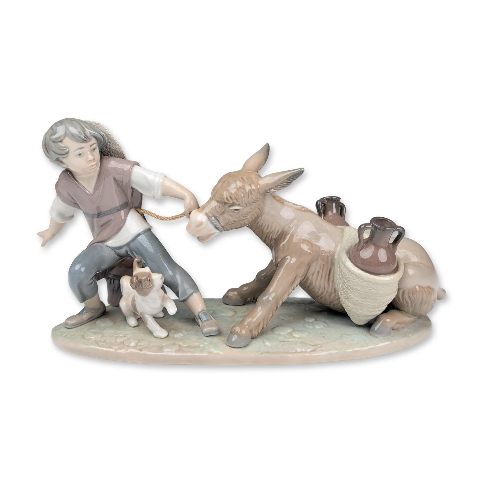 Lladro Porcelain Figurine, Stubborn Donkey 01005178: Lladro glazed porcelain figurine, titled Donkey's Love and also known as Stubborn Donkey, model number 5178, sculpted by Juan Huerta. The narrative scene depicts a boy in a wide-brimmed hat pulling a 