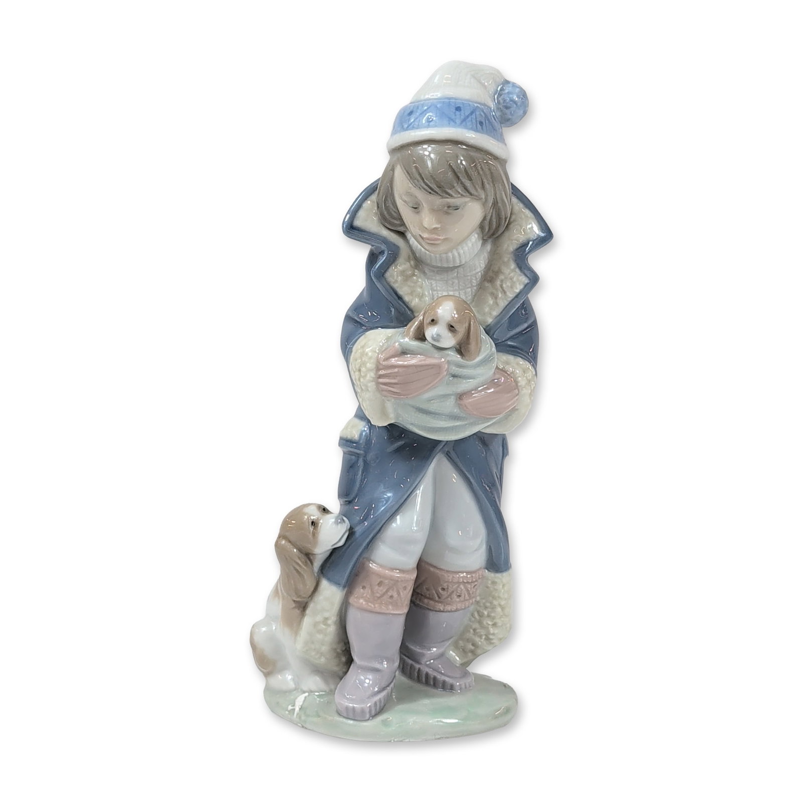 Lladro Porcelain Friday's Child 6019 Figurine: Lladro (Spanish, est. 1953). Friday's Child, model number 6019, glazed porcelain figurine. The sculpture depicts a child in winter clothing, featuring a blue hooded coat with white trim and a knit hat