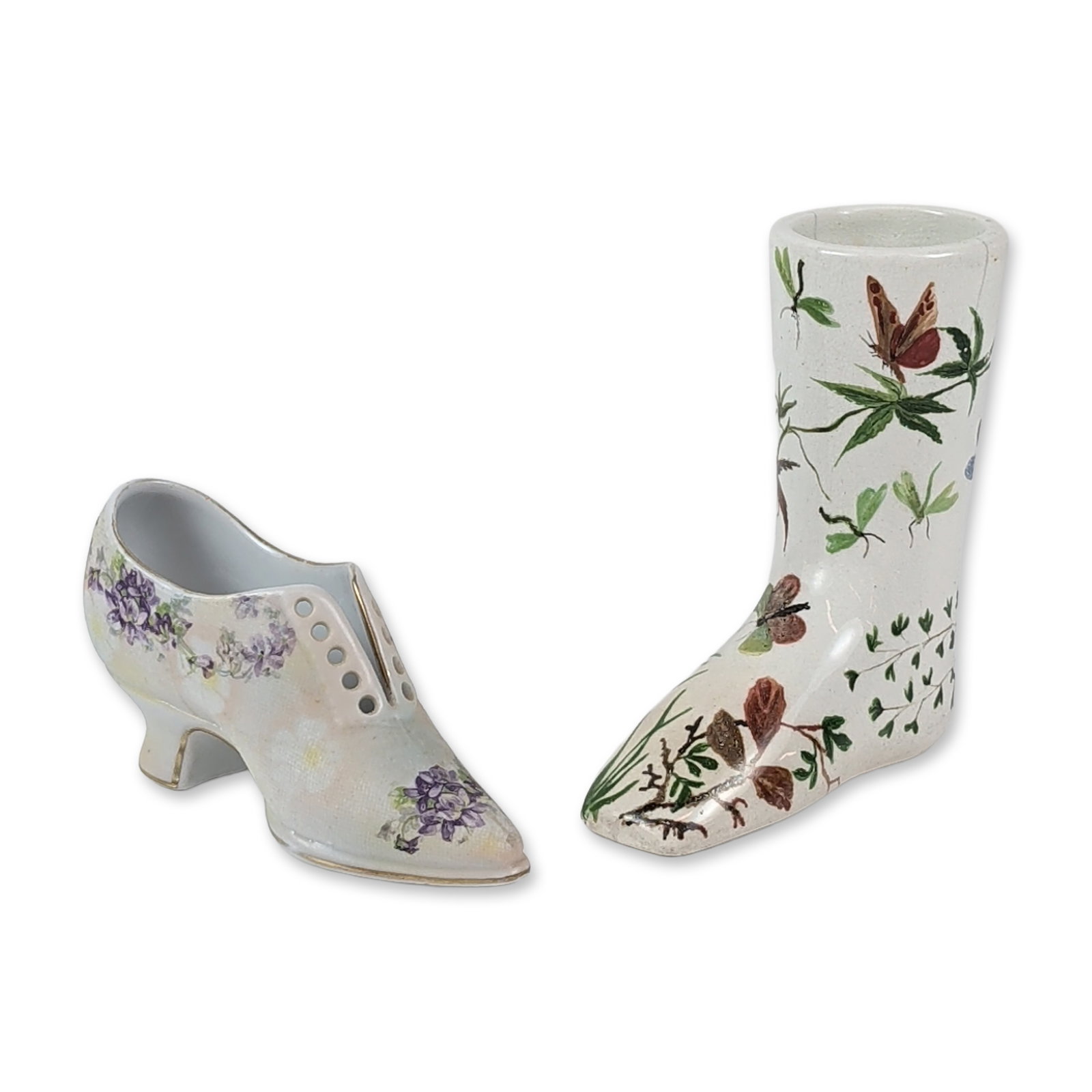 2pc Porcelain Shoe Figurines including Royal Bayreuth: Two porcelain decorative items modeled as footwear. The first is a tall boot-form bud vase featuring polychrome butterfly, caterpillar, and botanical decoration on a white ground. The base is marked w